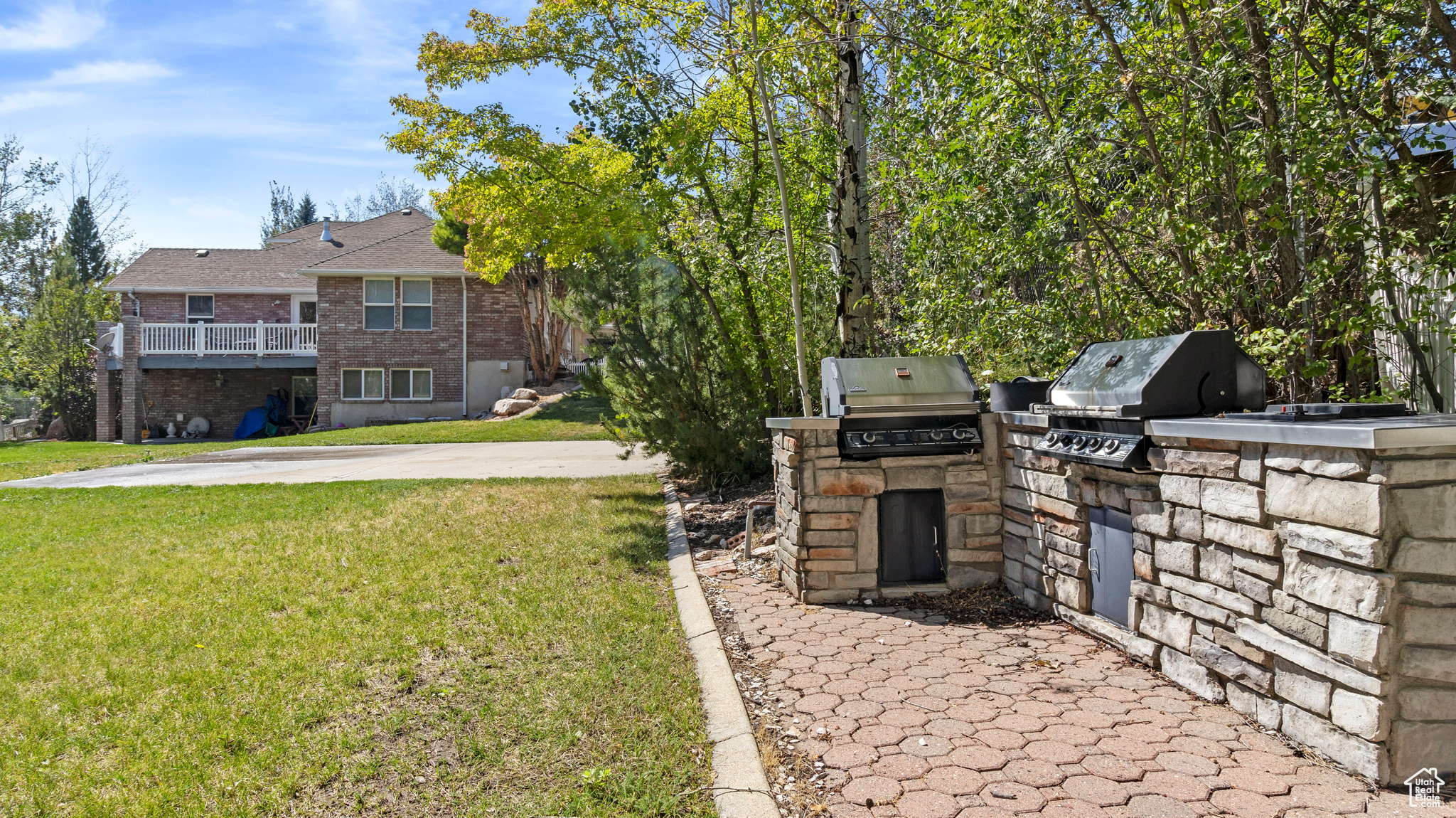 View of yard featuring exterior kitchen and a balcony