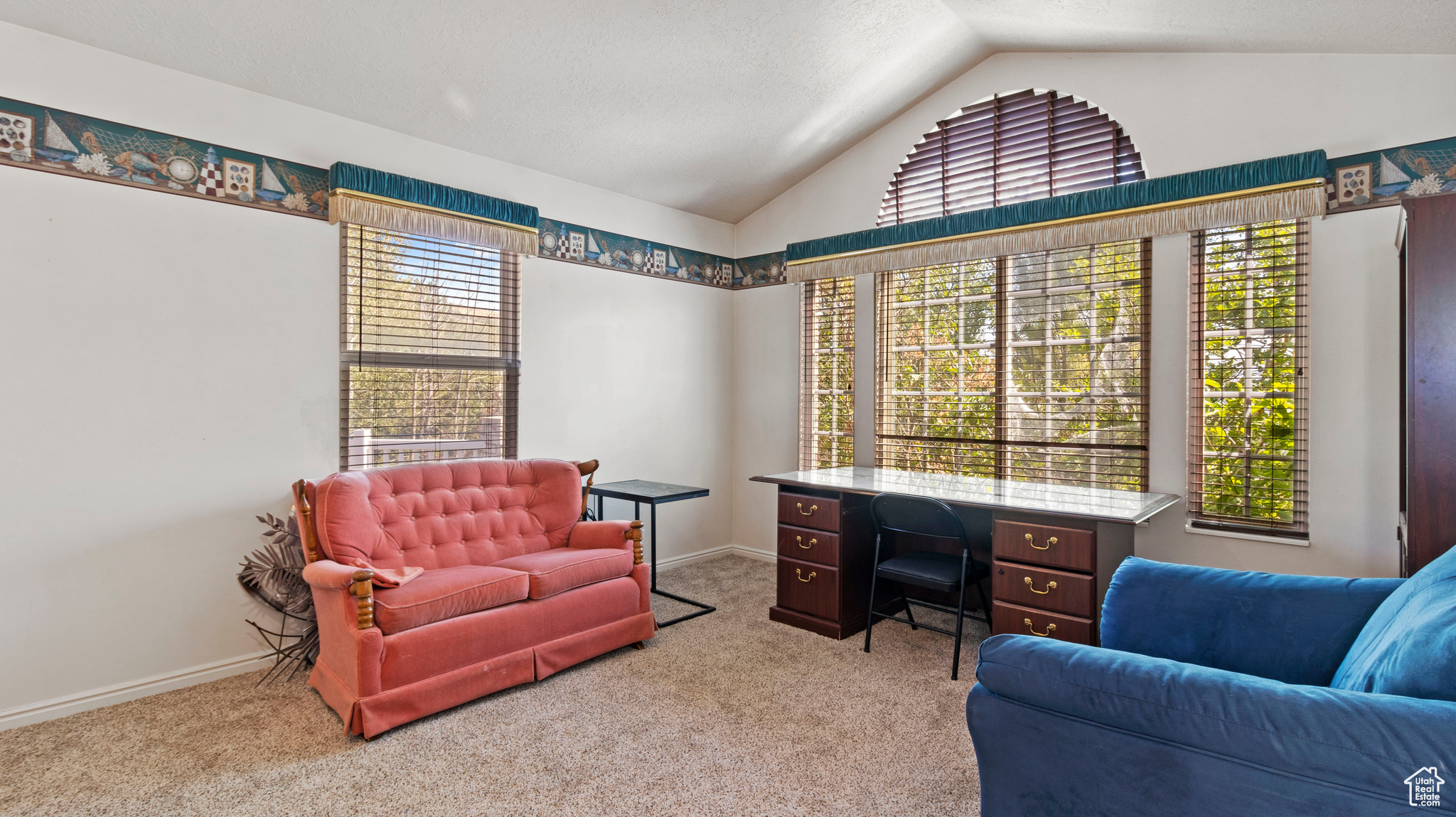 Interior space featuring vaulted ceiling and a healthy amount of sunlight