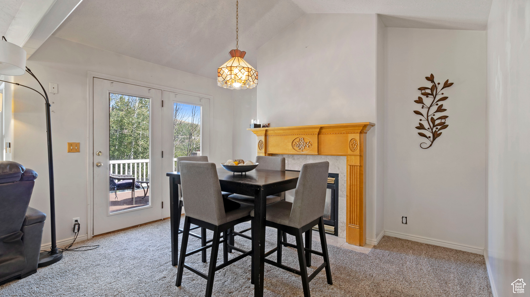 Dining room featuring light carpet and vaulted ceiling