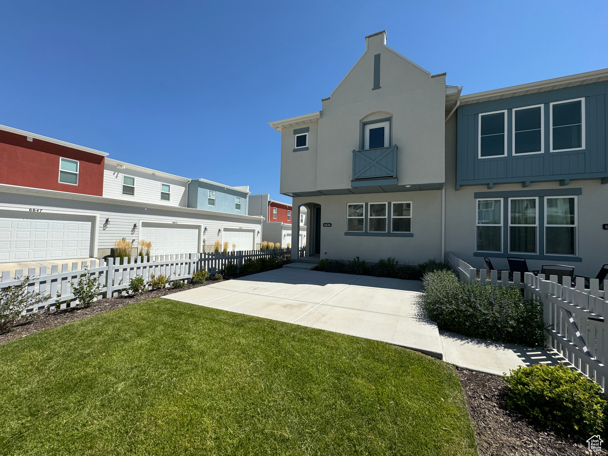 View of front of property featuring a garage and a front lawn