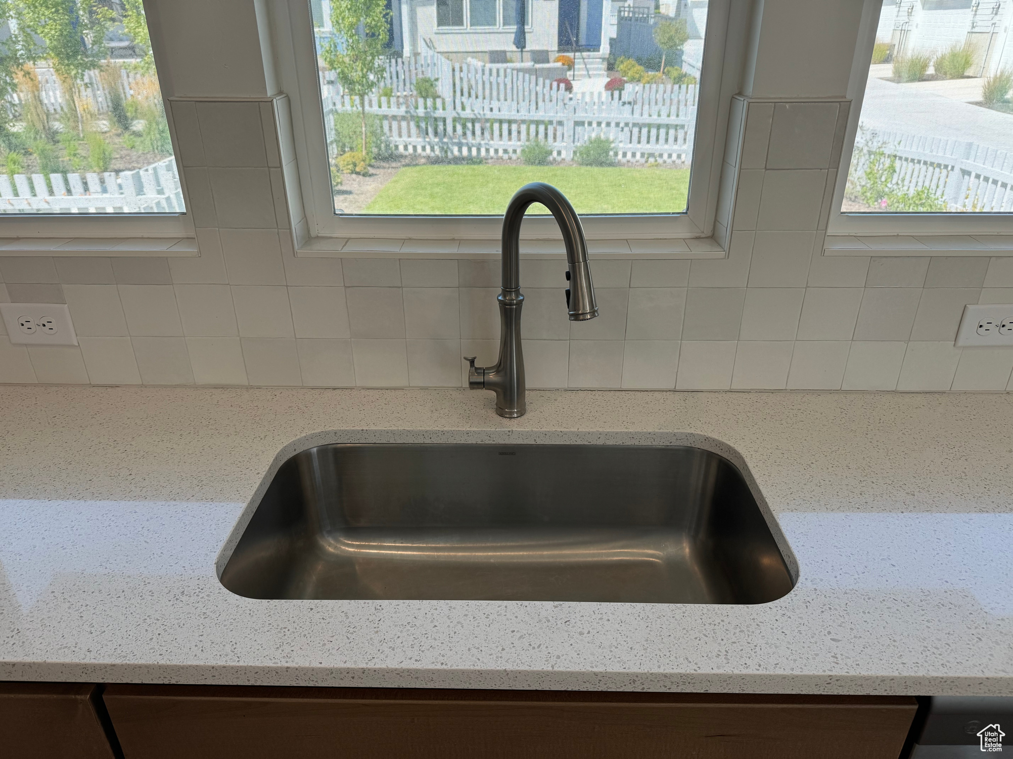 Room details featuring light stone counters and sink