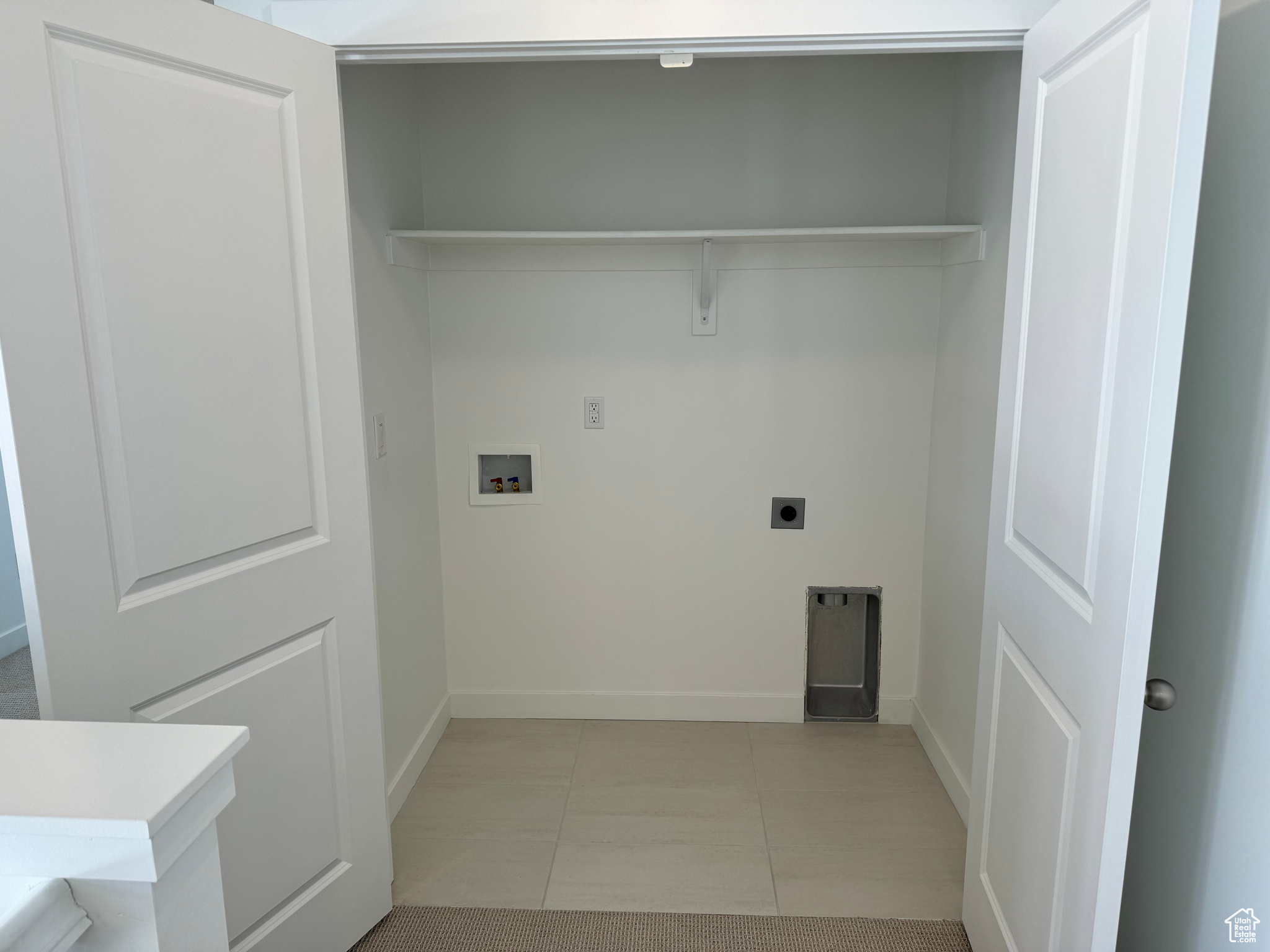 Laundry room featuring light tile patterned floors, electric dryer hookup, and washer hookup