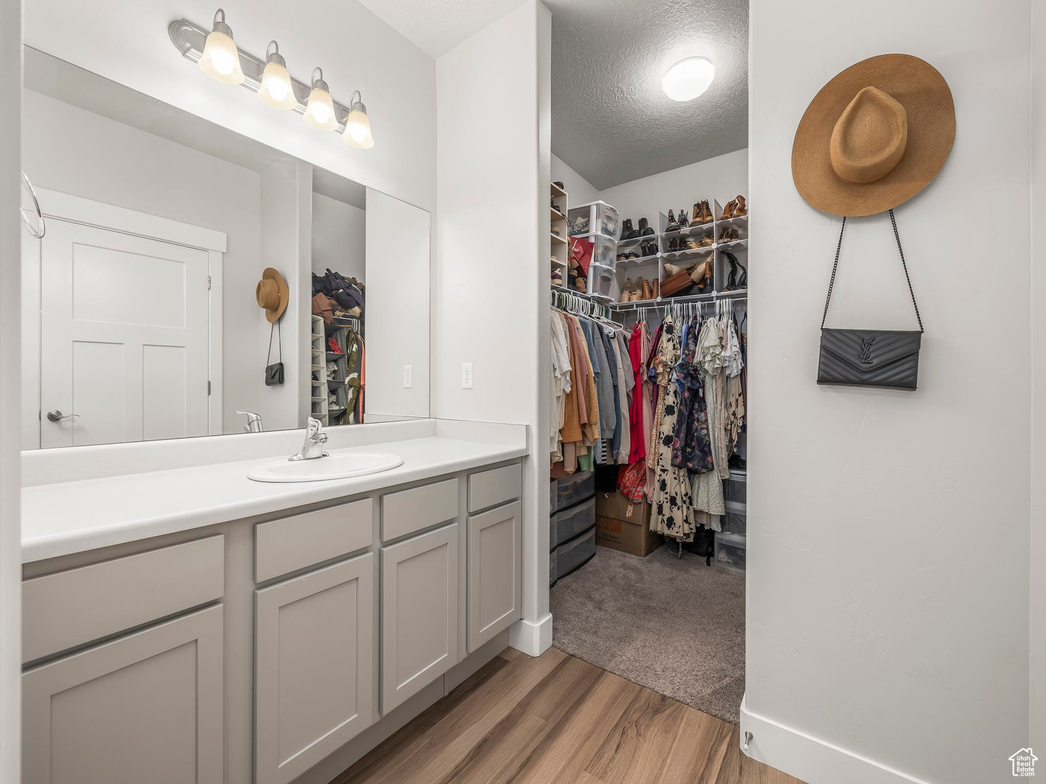 Bathroom with vanity, a textured ceiling, and hardwood / wood-style flooring