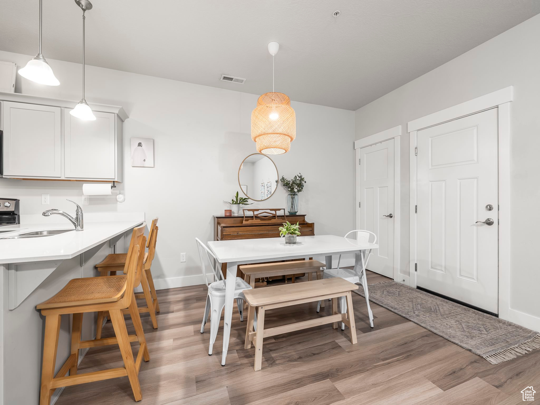 Dining space with sink and light hardwood / wood-style floors