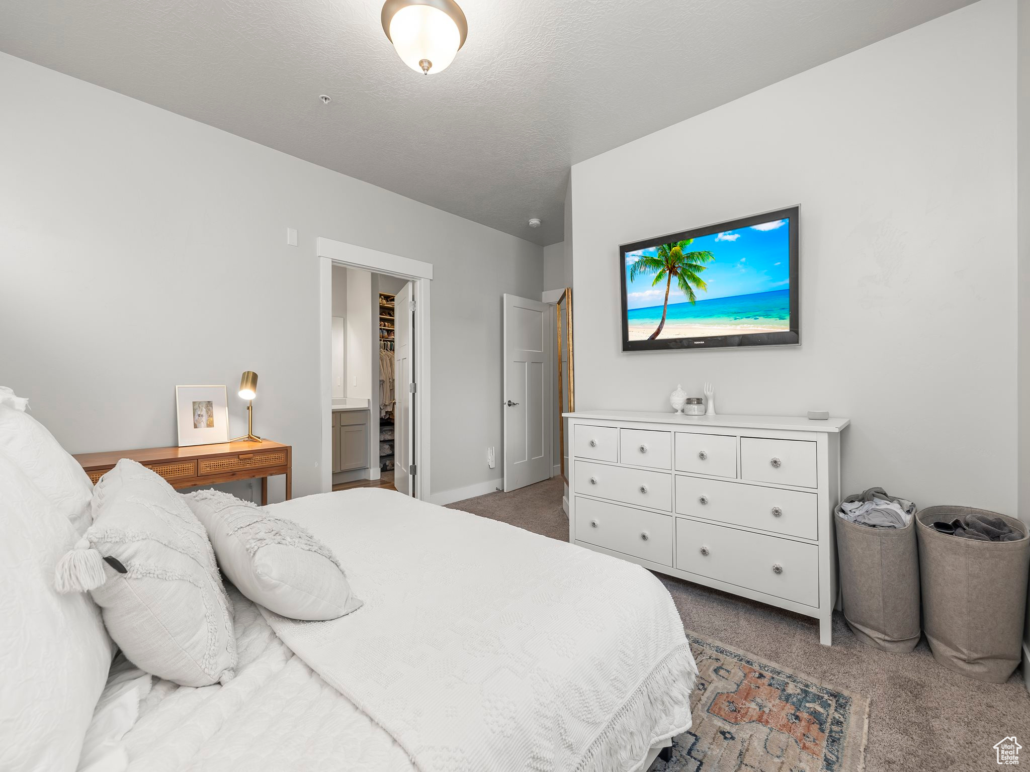 Carpeted bedroom with a textured ceiling