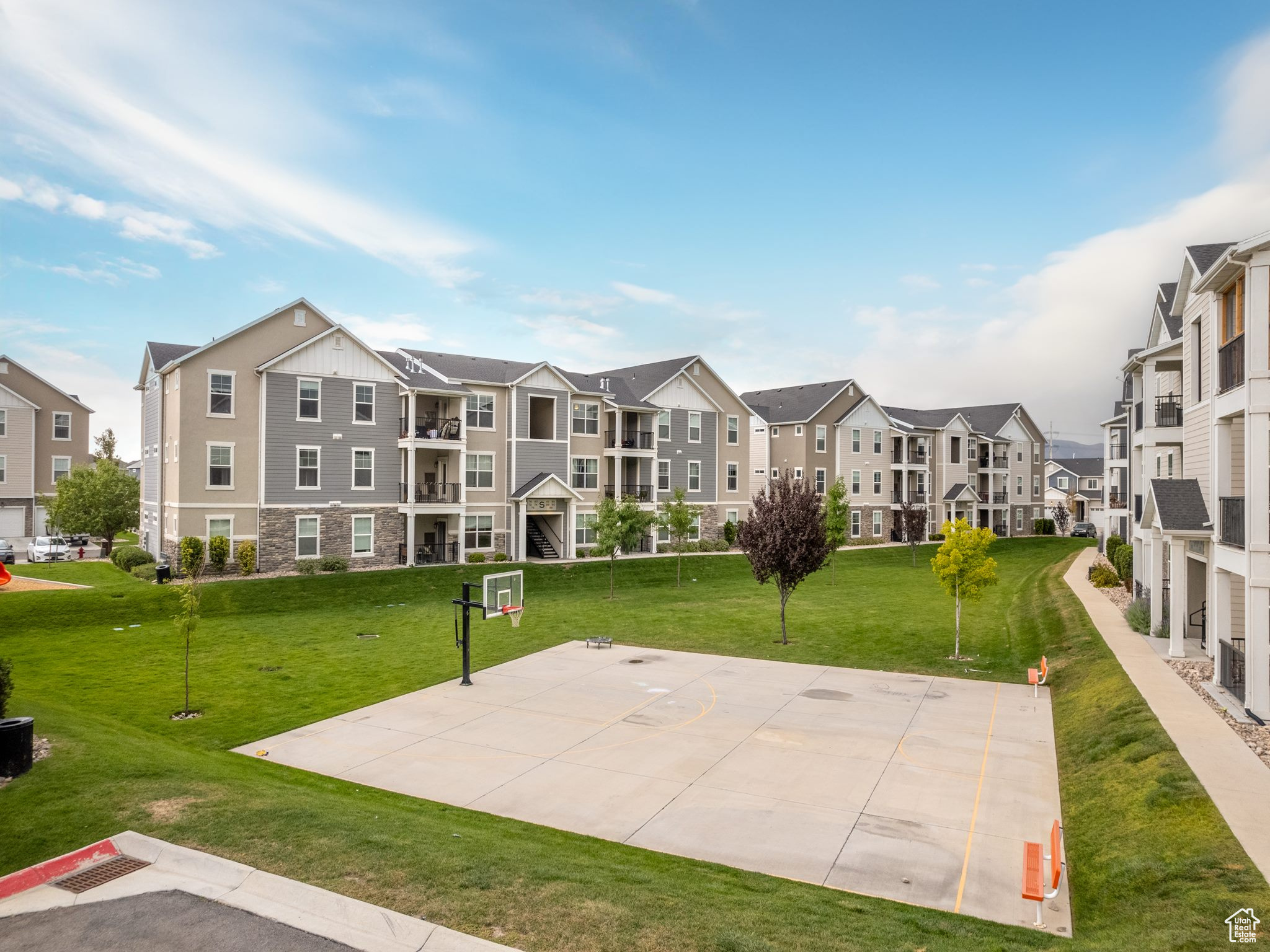 View of property's community featuring a yard and basketball hoop