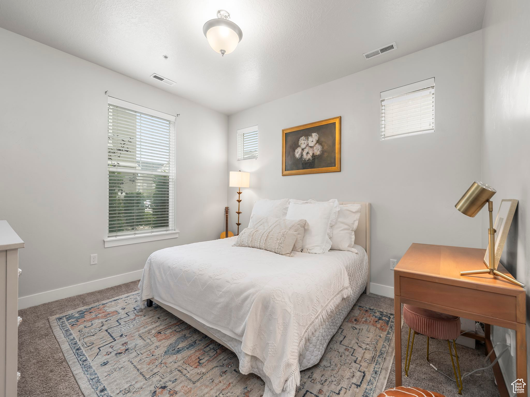 Bedroom with light carpet