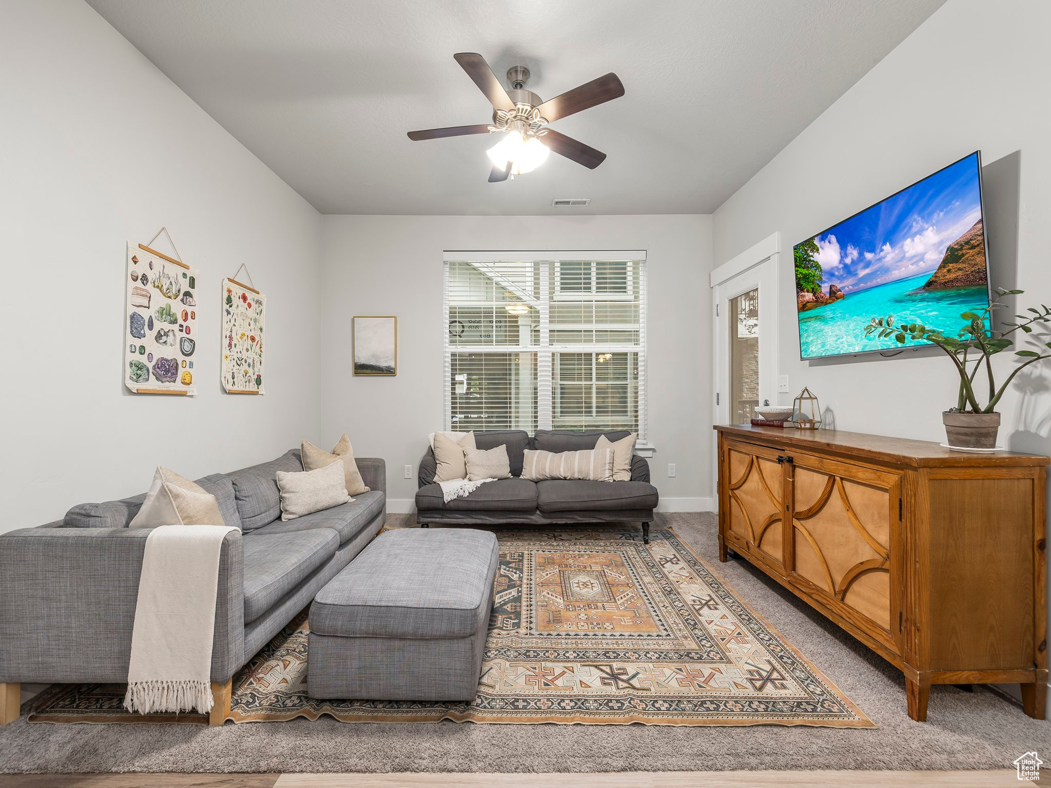 Living room with ceiling fan and carpet floors