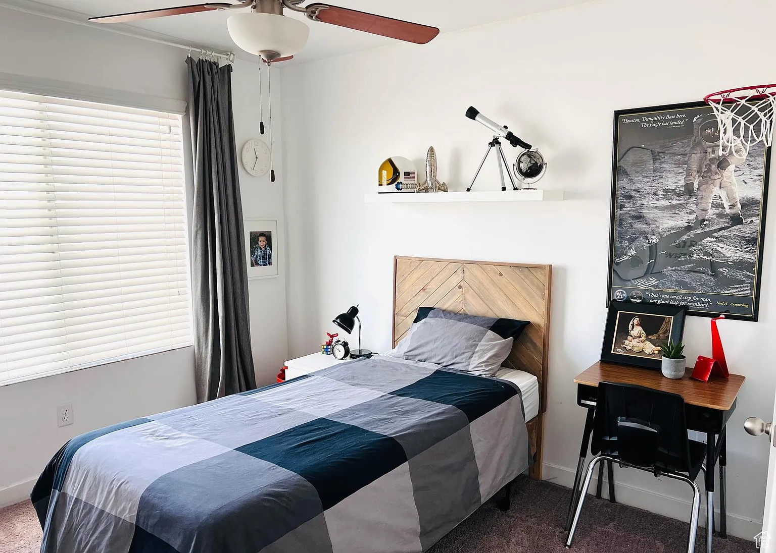 Carpeted bedroom with ceiling fan