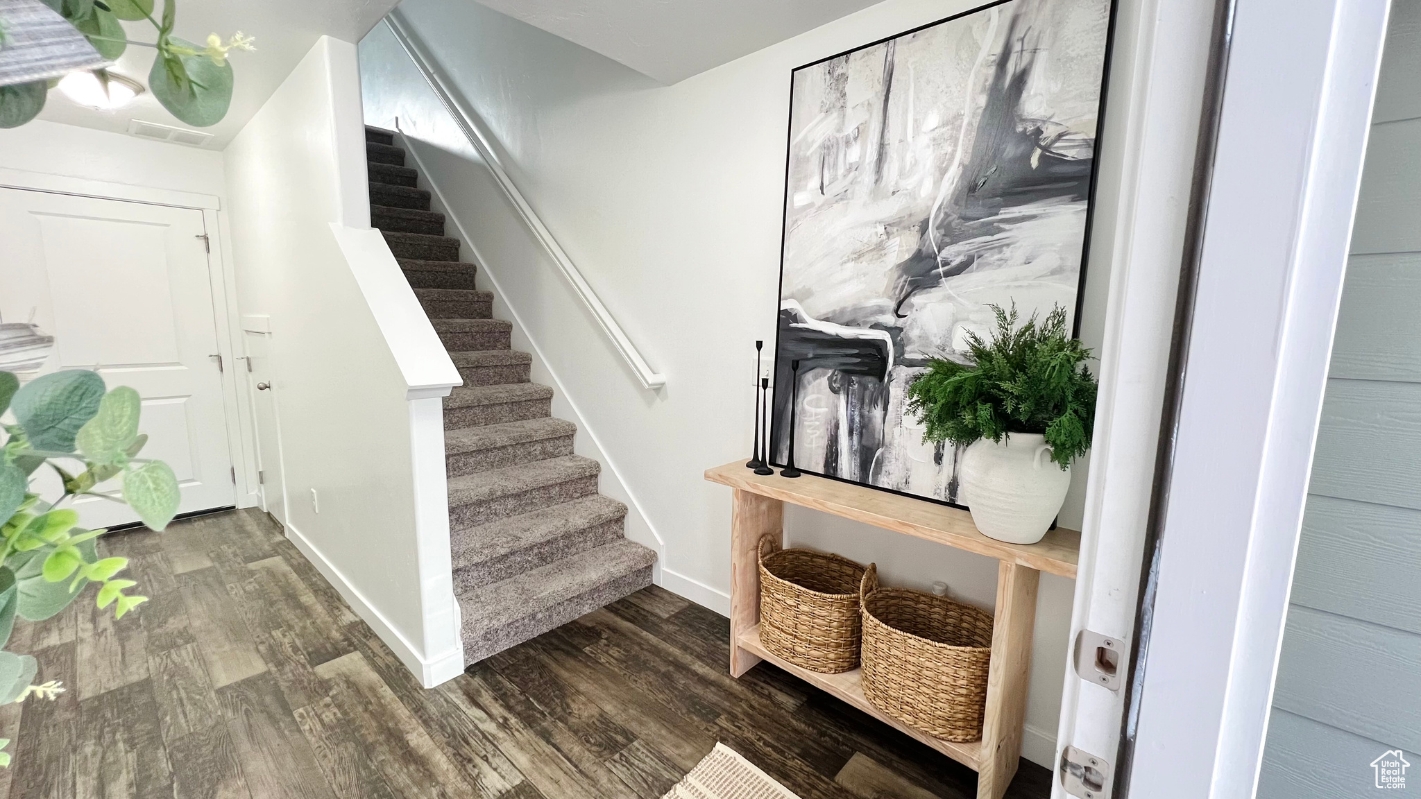 Staircase featuring hardwood / wood-style floors