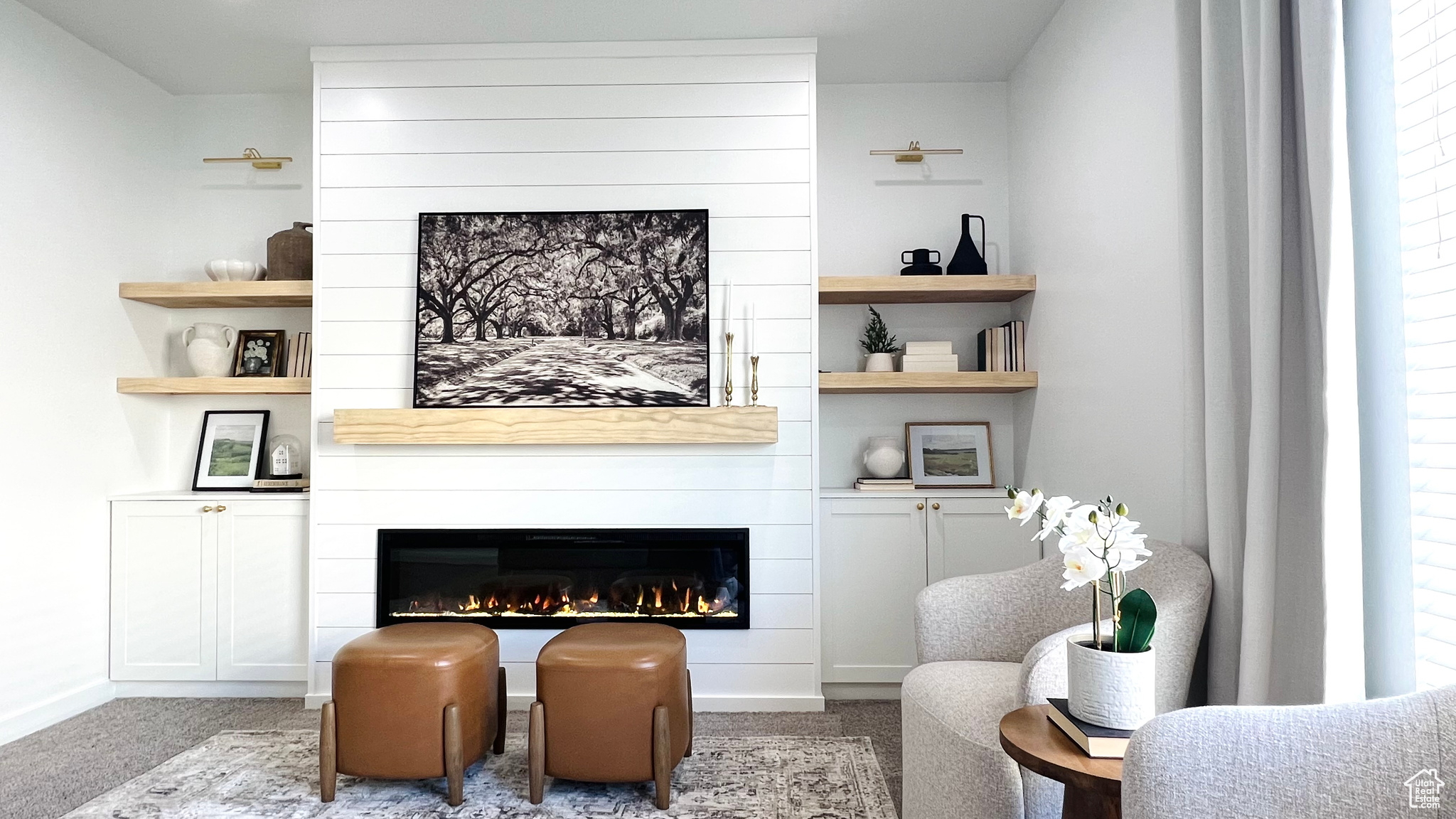 Sitting room with a healthy amount of sunlight, carpet floors, and a fireplace