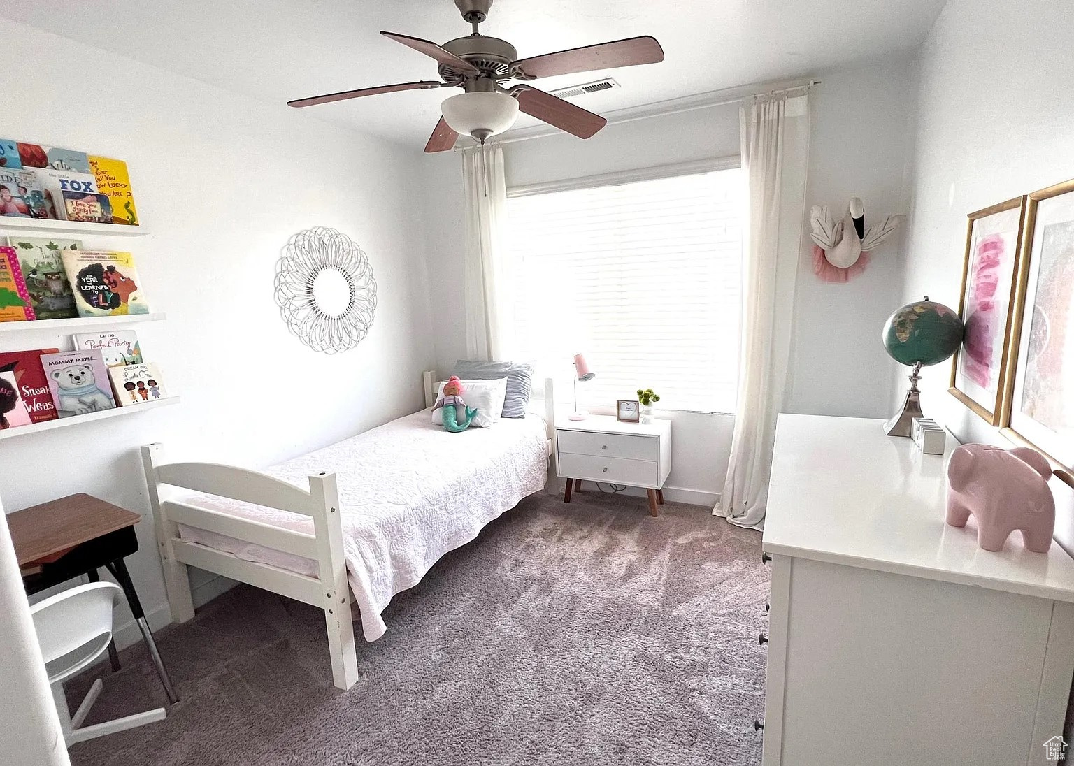 Bedroom with dark colored carpet and ceiling fan