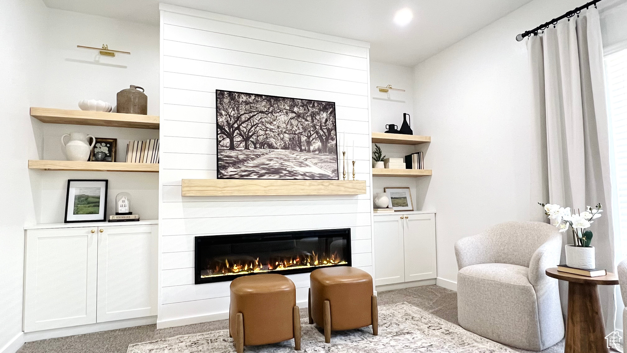 Living area with a fireplace and light carpet