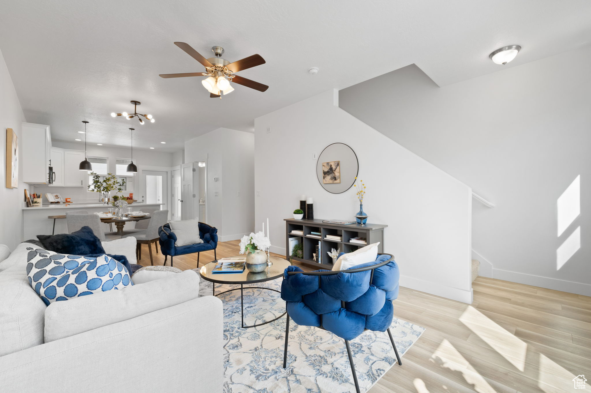 Living room featuring light hardwood / wood-style flooring and ceiling fan