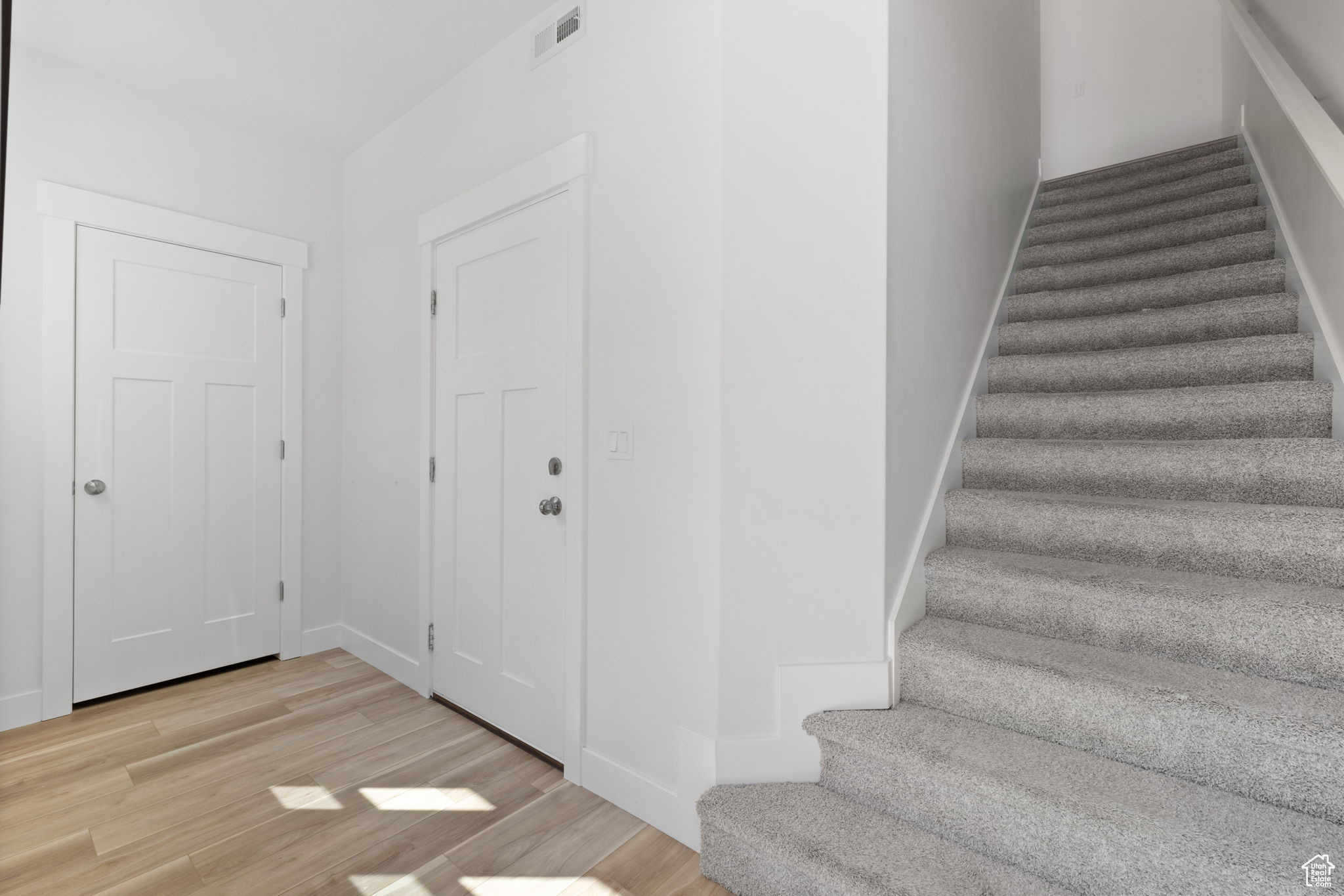 Stairway with hardwood / wood-style floors