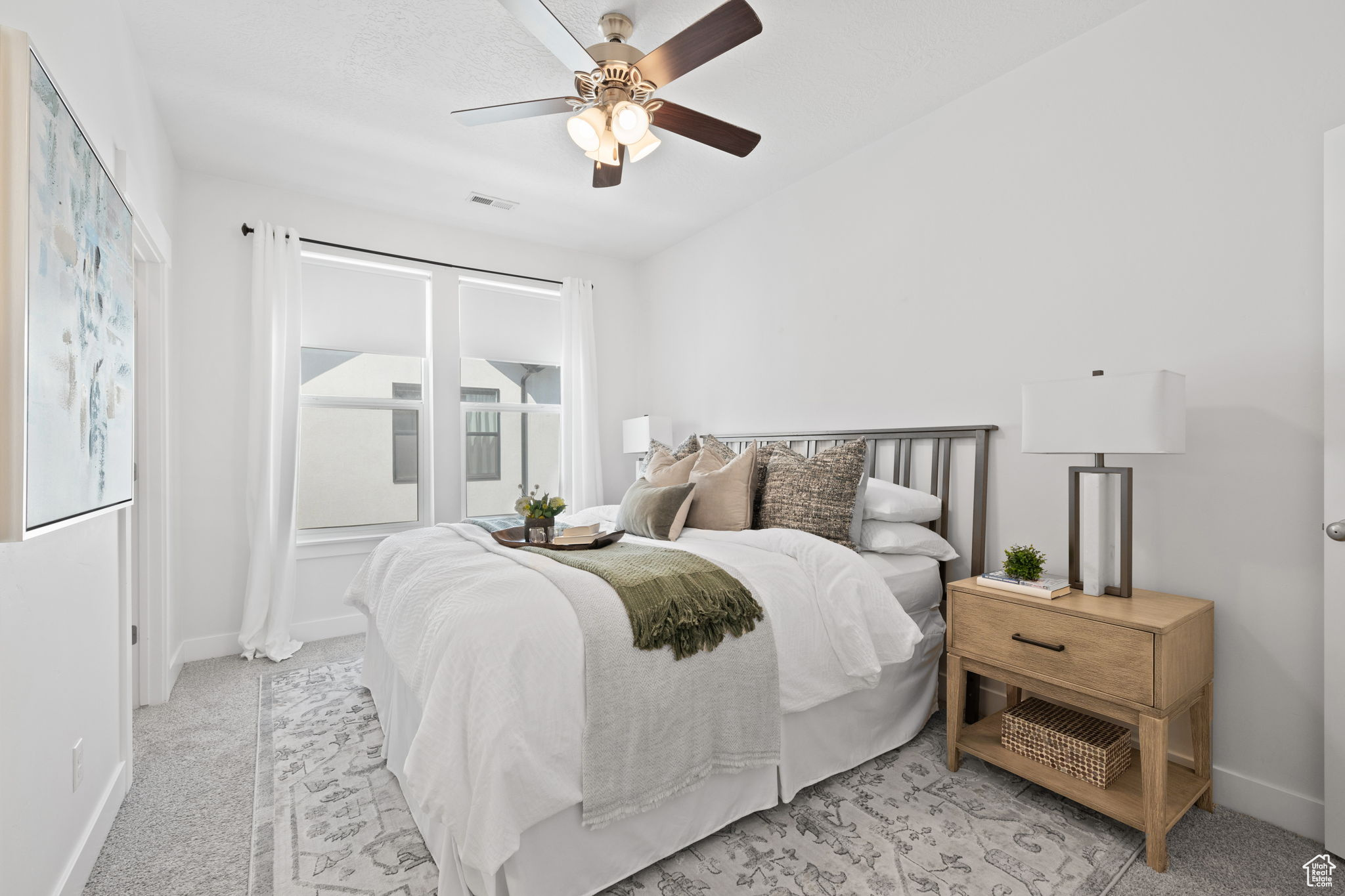 Carpeted bedroom with ceiling fan