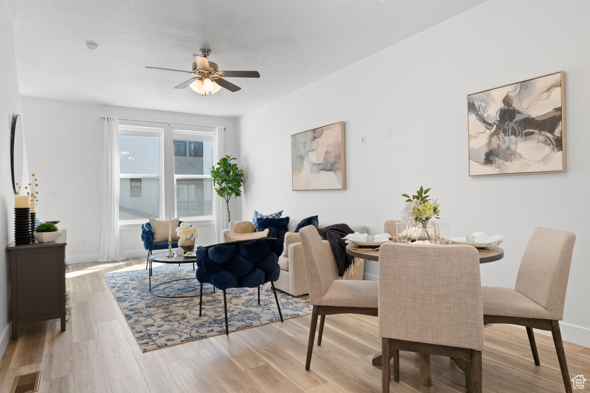 Dining area with light hardwood / wood-style flooring and ceiling fan