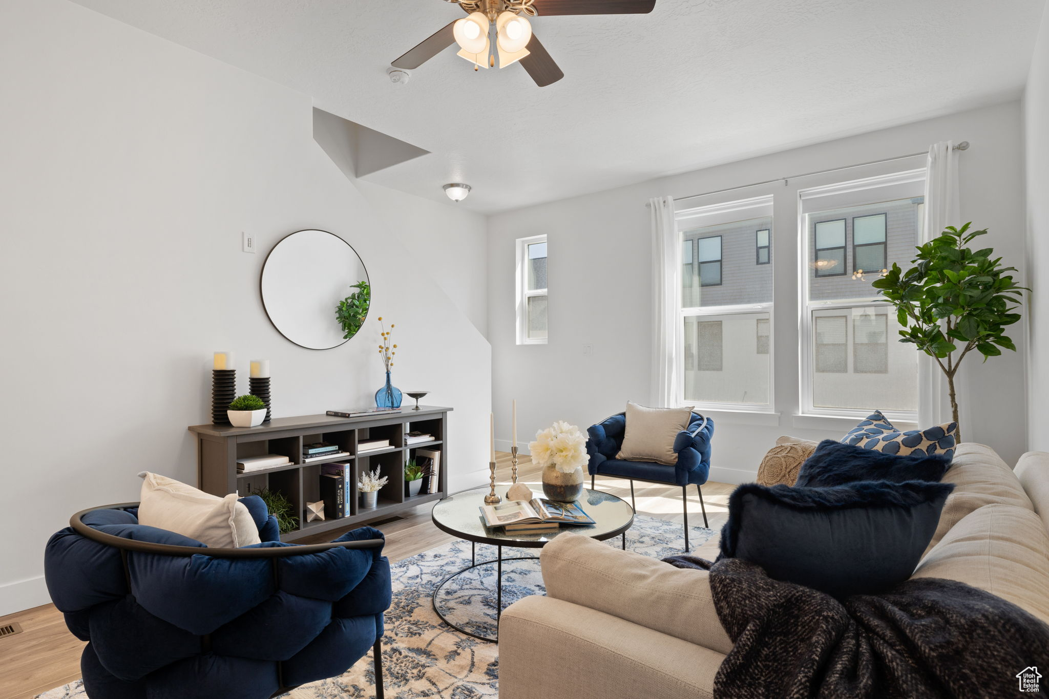 Living room with wood-type flooring and ceiling fan