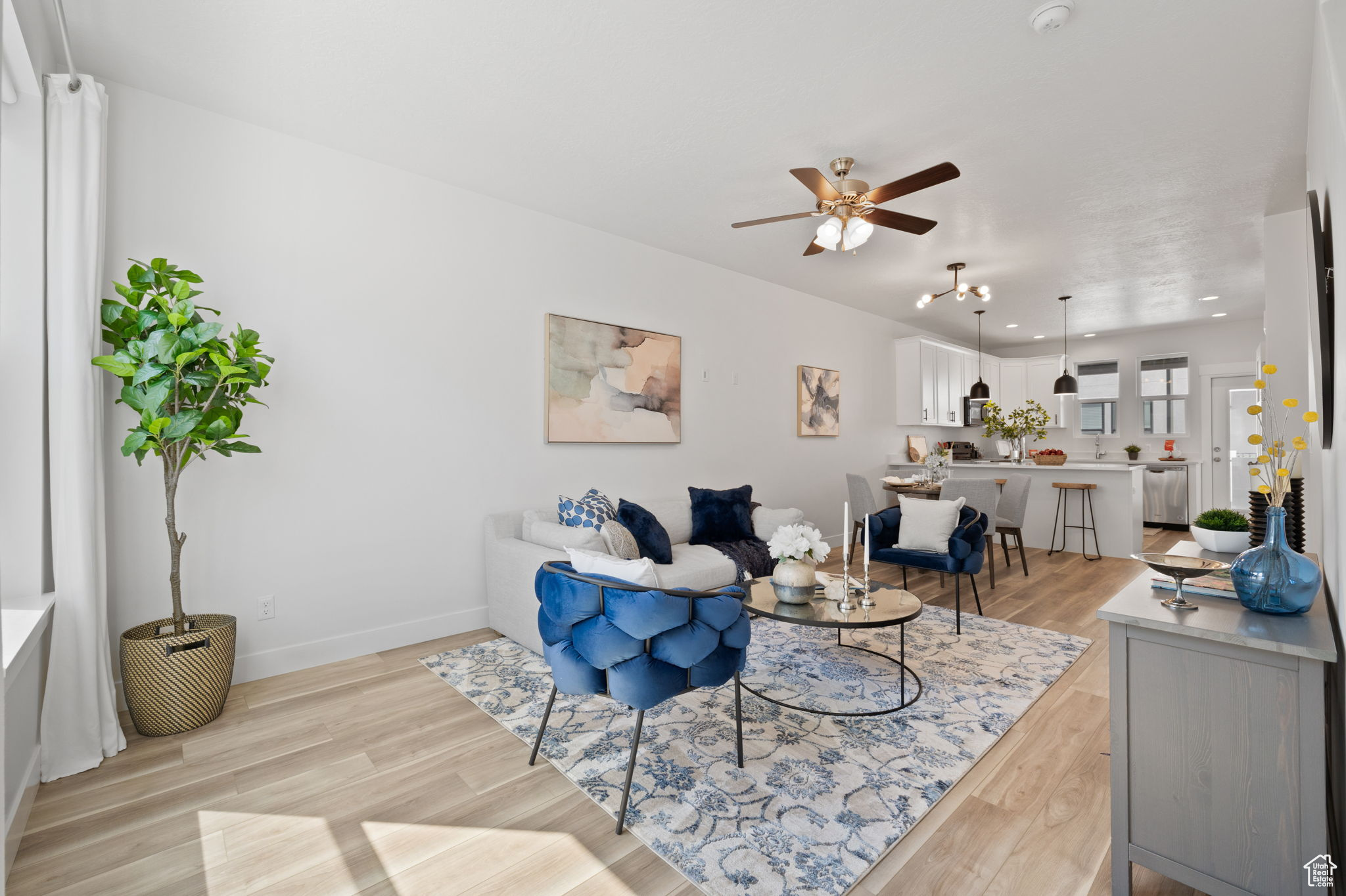 Living room with light wood-type flooring and ceiling fan