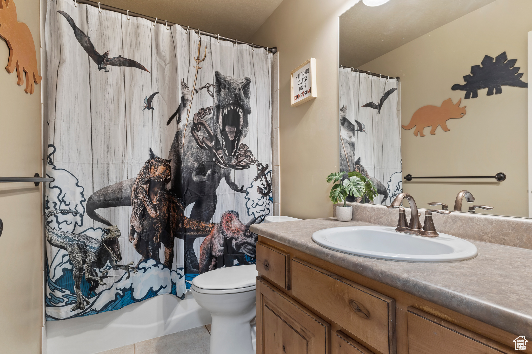 Full bathroom featuring tile patterned flooring, shower / bath combo, vanity, and toilet