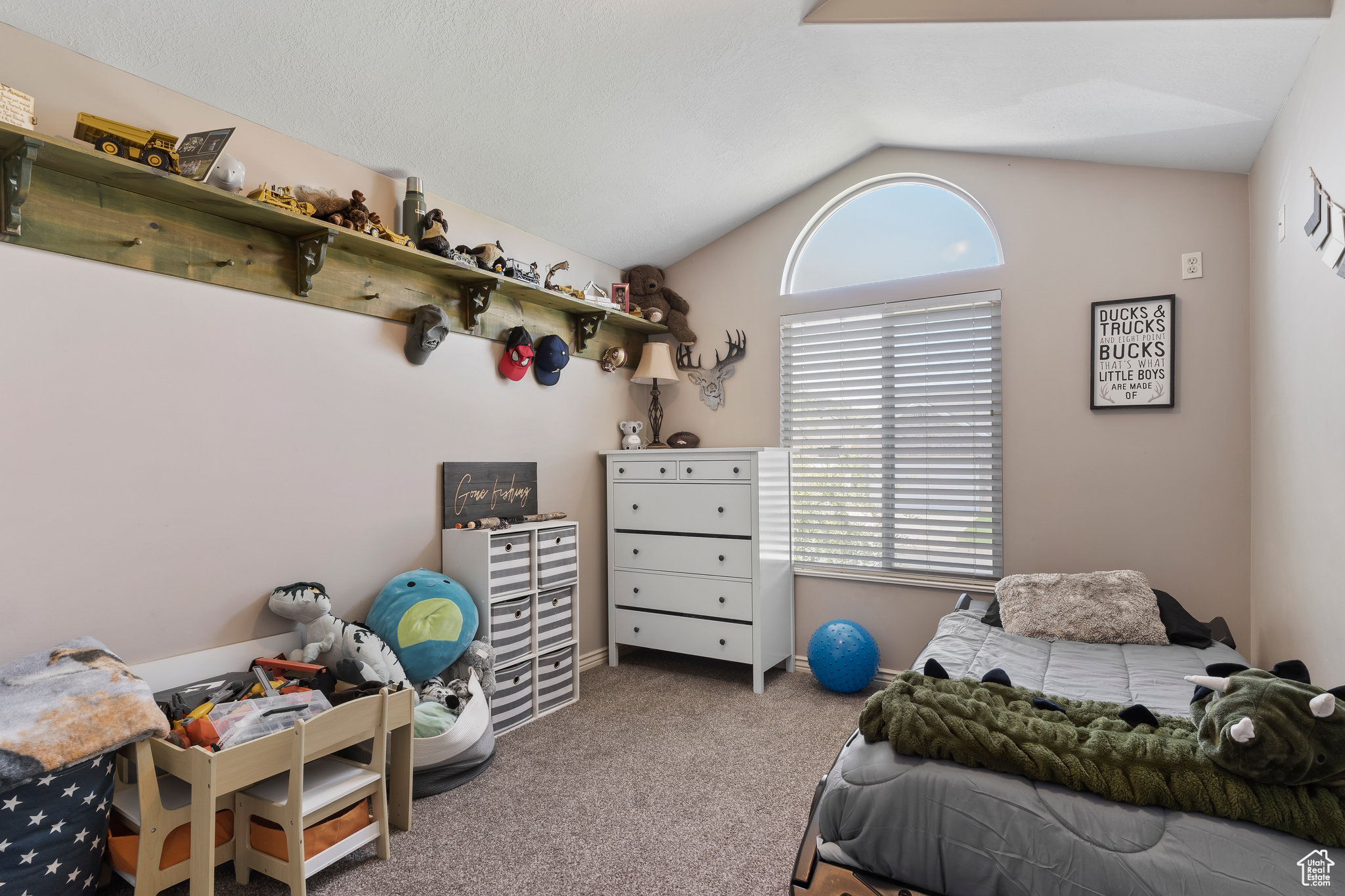 Bedroom featuring lofted ceiling and carpet