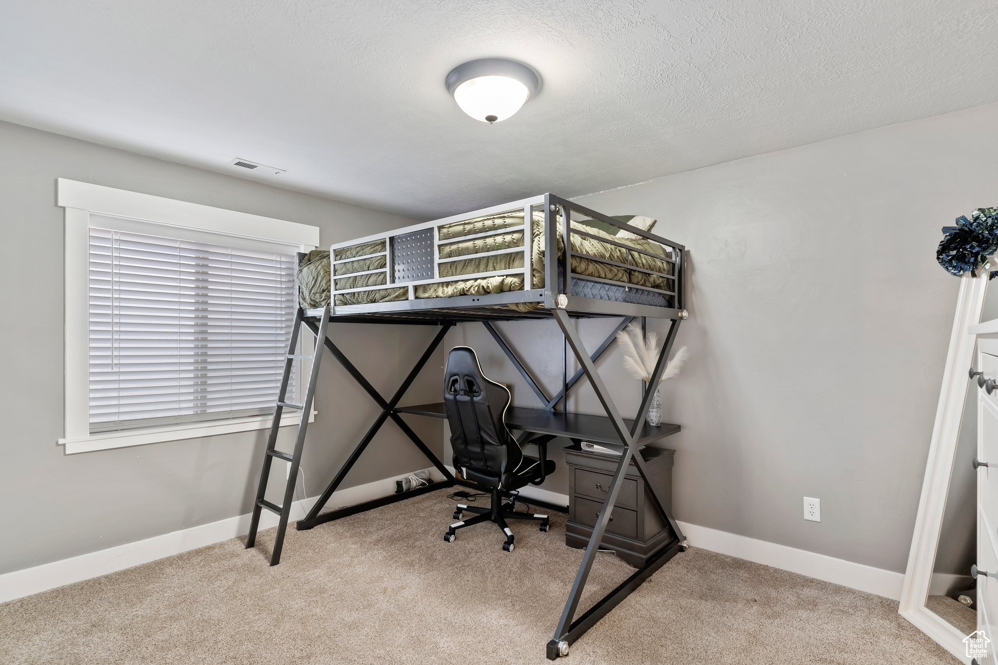 Bedroom with carpet floors and a textured ceiling