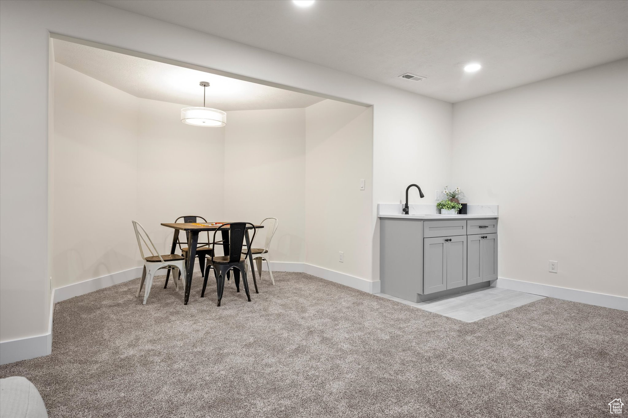 Dining room featuring sink and light colored carpet