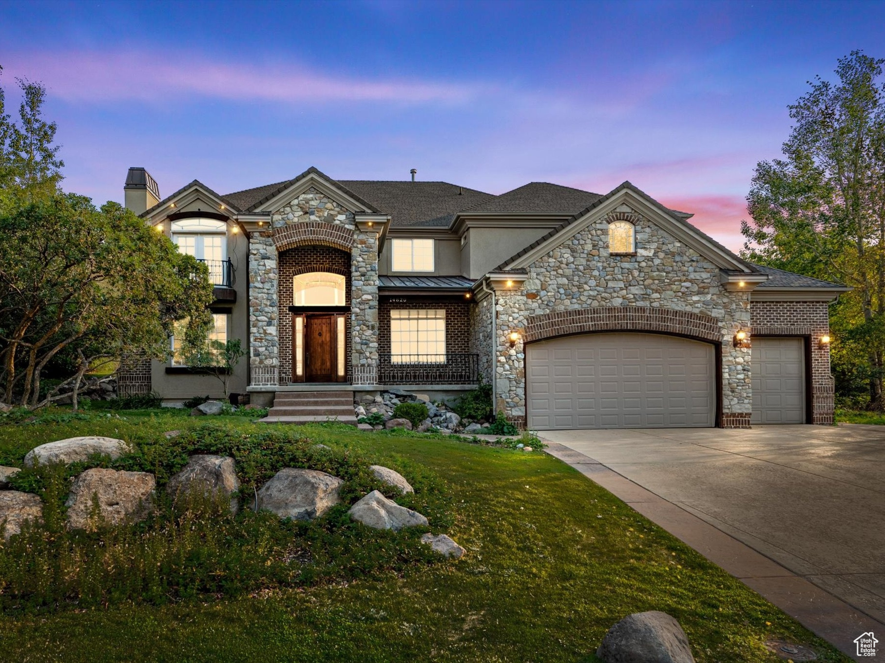 French country style house featuring a garage and a yard