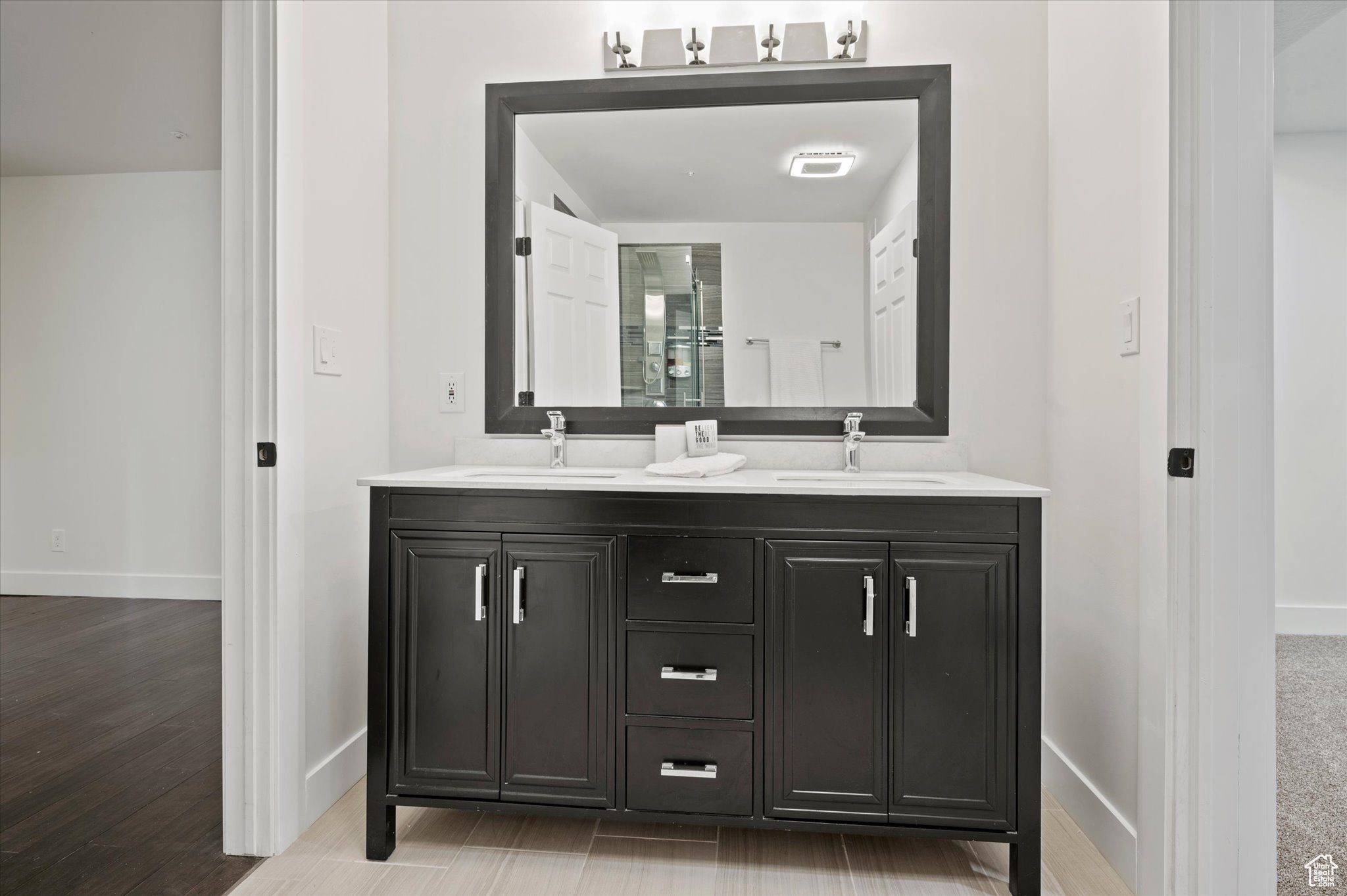 Bathroom featuring vanity and wood-type flooring