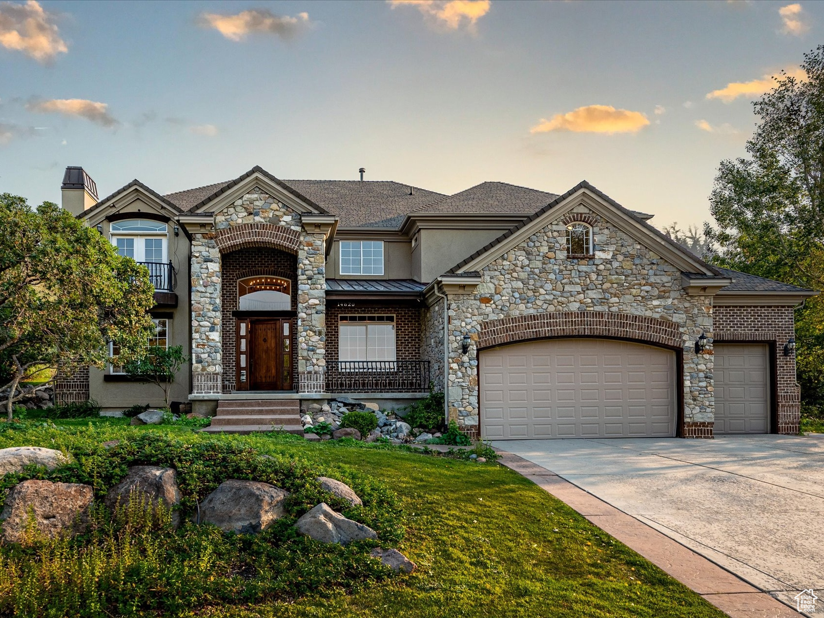 View of front of house with a garage and a yard