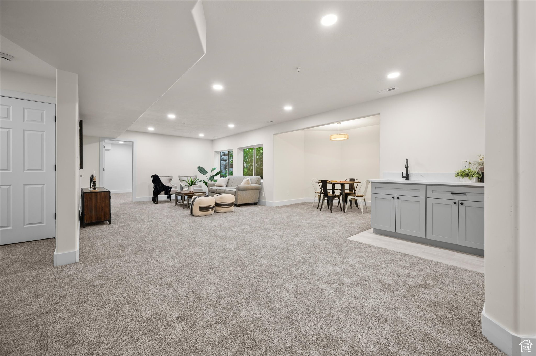 Carpeted living room with sink