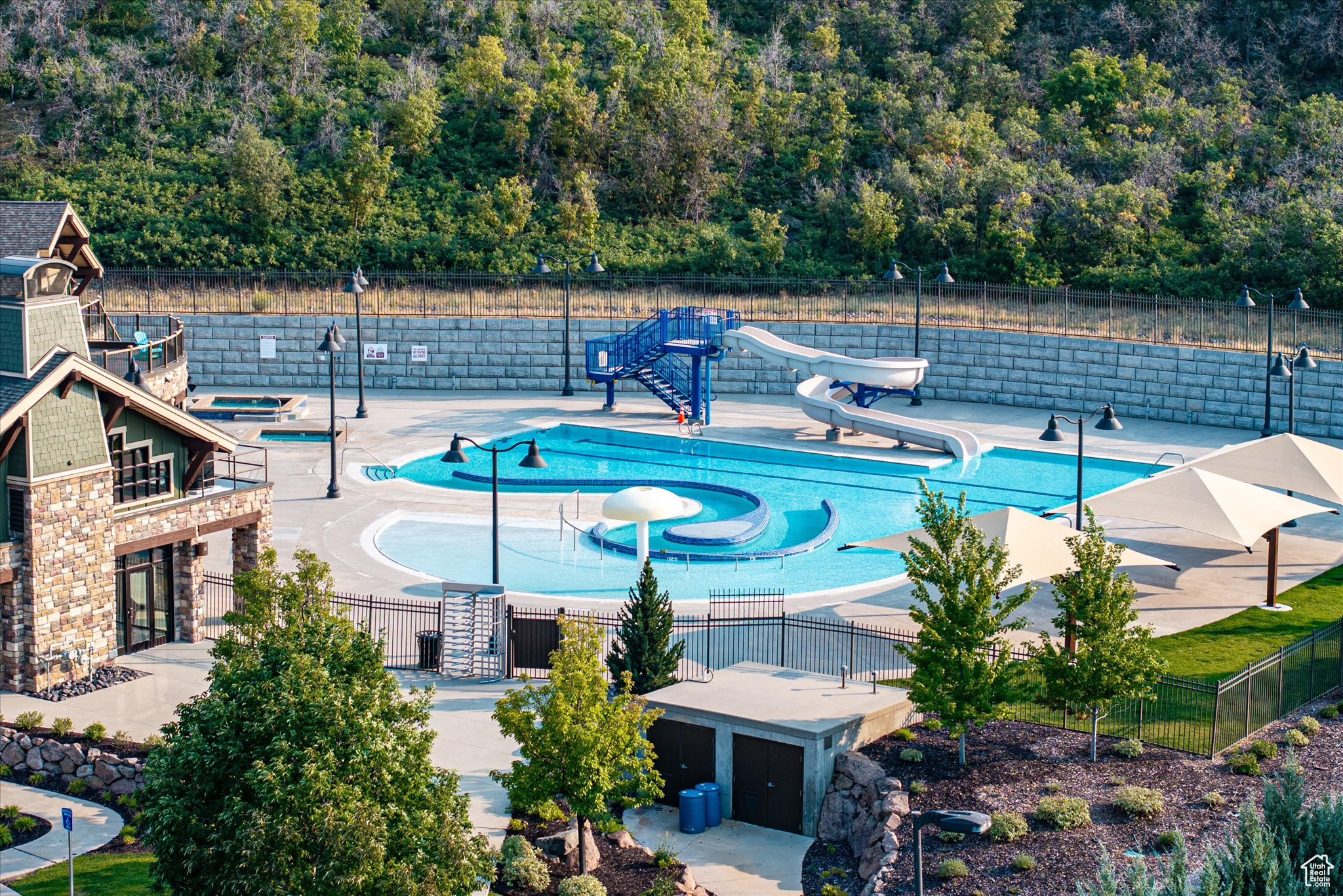 View of pool with a water slide and a patio