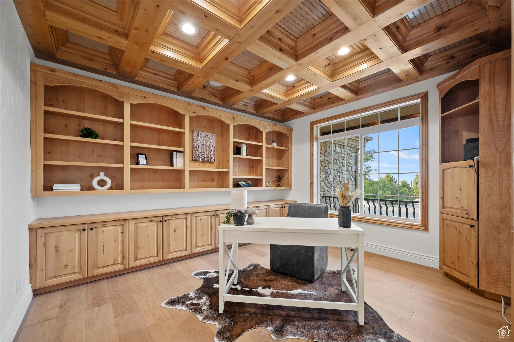 Home office with wooden ceiling, coffered ceiling, beamed ceiling, and light hardwood / wood-style flooring