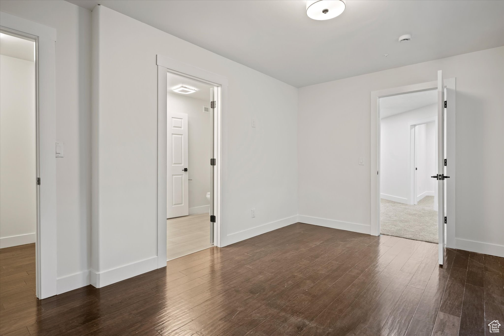 Spare room featuring dark hardwood / wood-style flooring