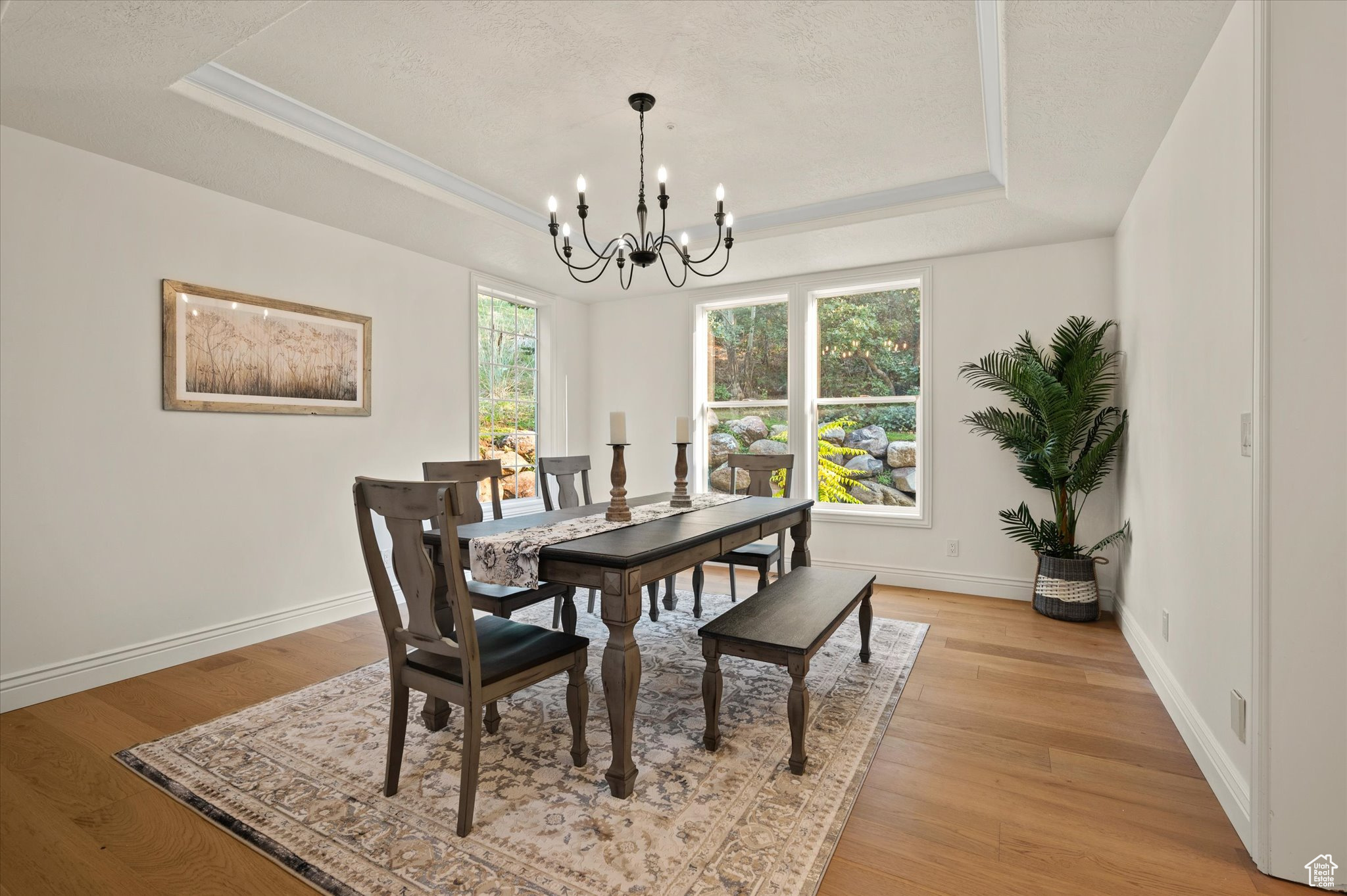 Dining room with a coffered ceiling, light hardwood / wood-style flooring,