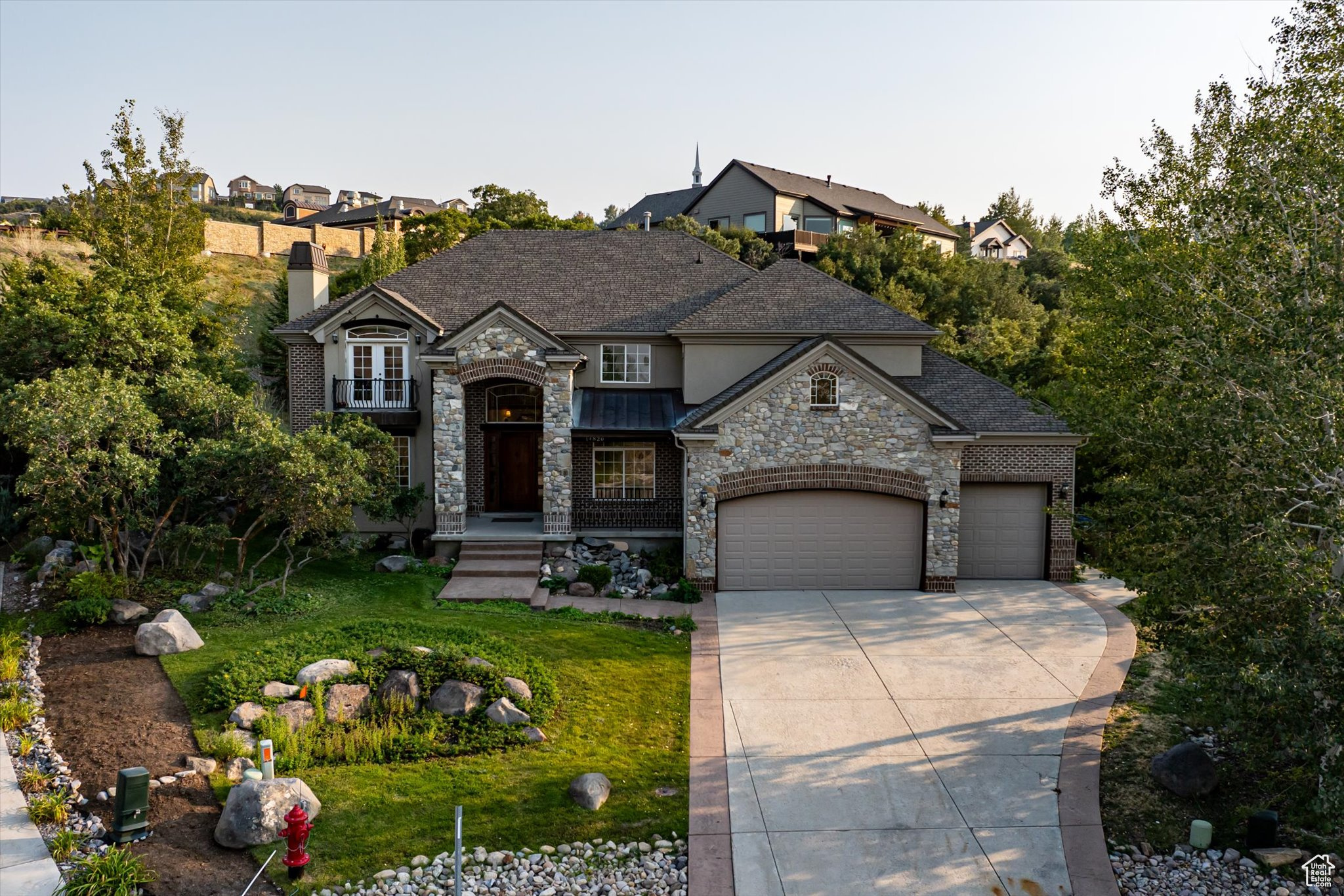 French provincial home with a front yard and a garage