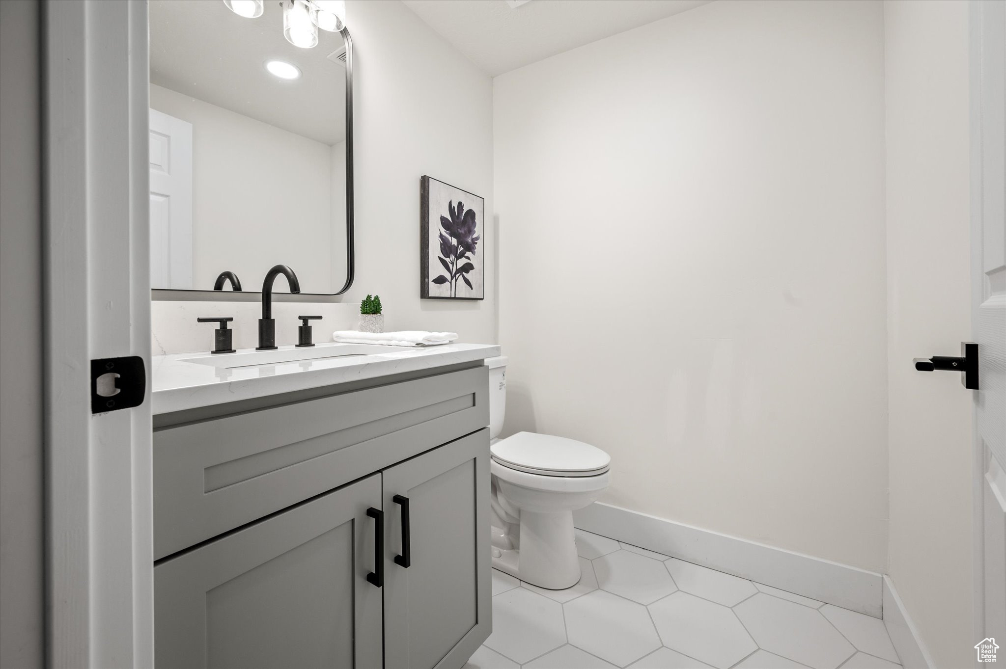 Bathroom featuring vanity, toilet, and tile patterned floors