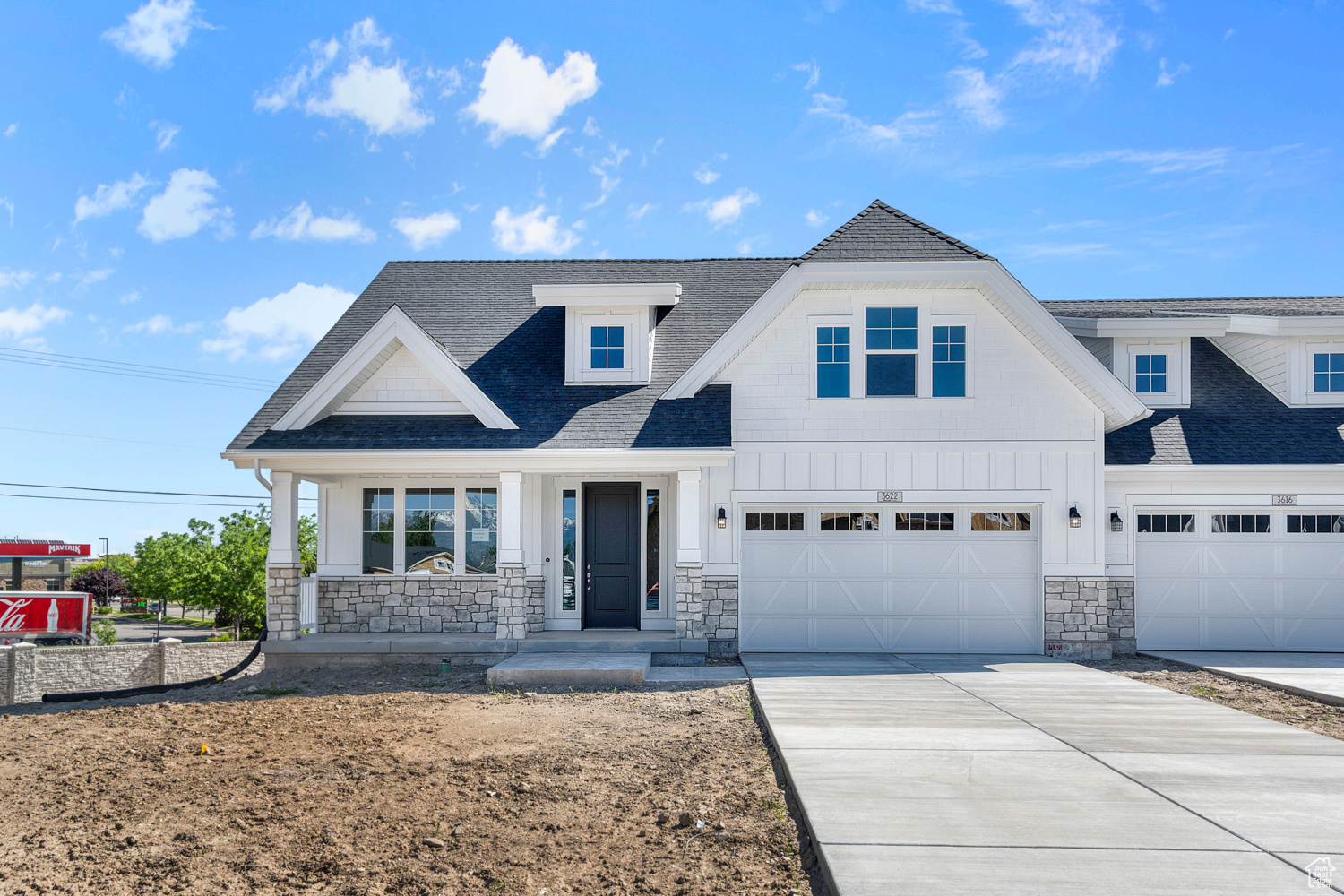 View of front facade featuring a porch and a garage