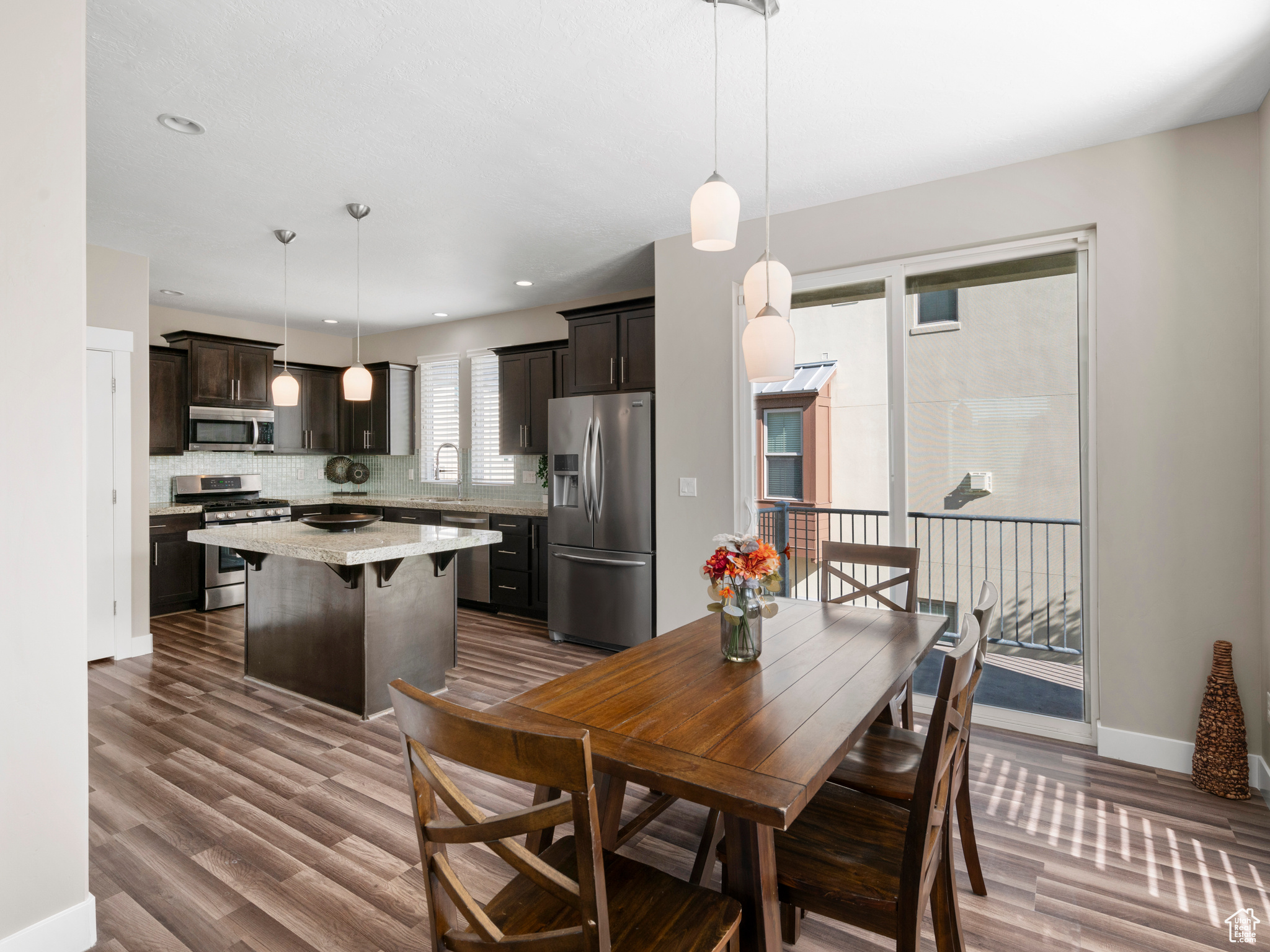 Dining area featuring dark wood-type flooring and granite counter tops