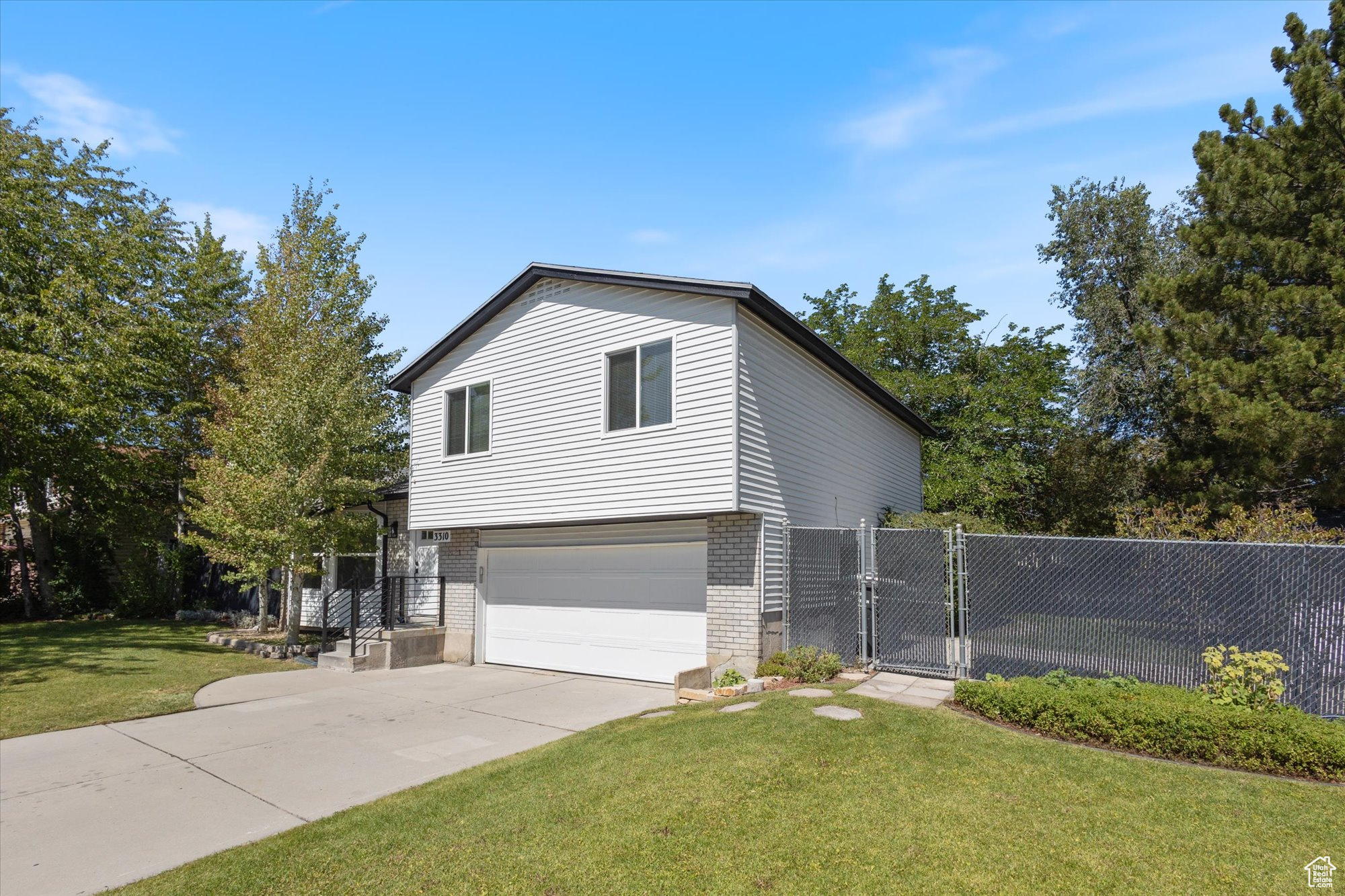 View of front of home featuring a garage and a front lawn