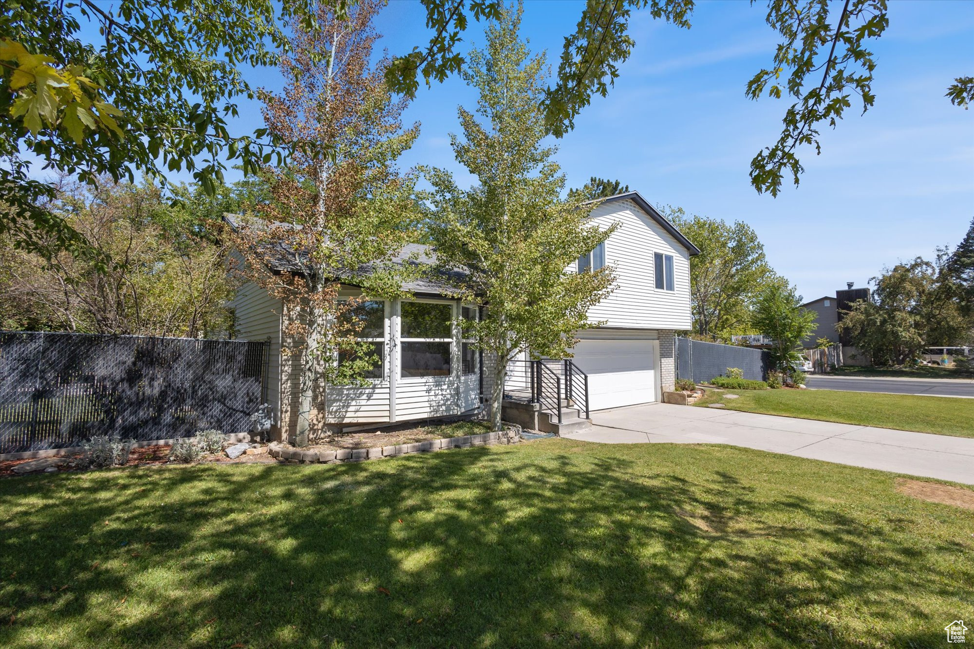 Obstructed view of property featuring a garage and a front lawn