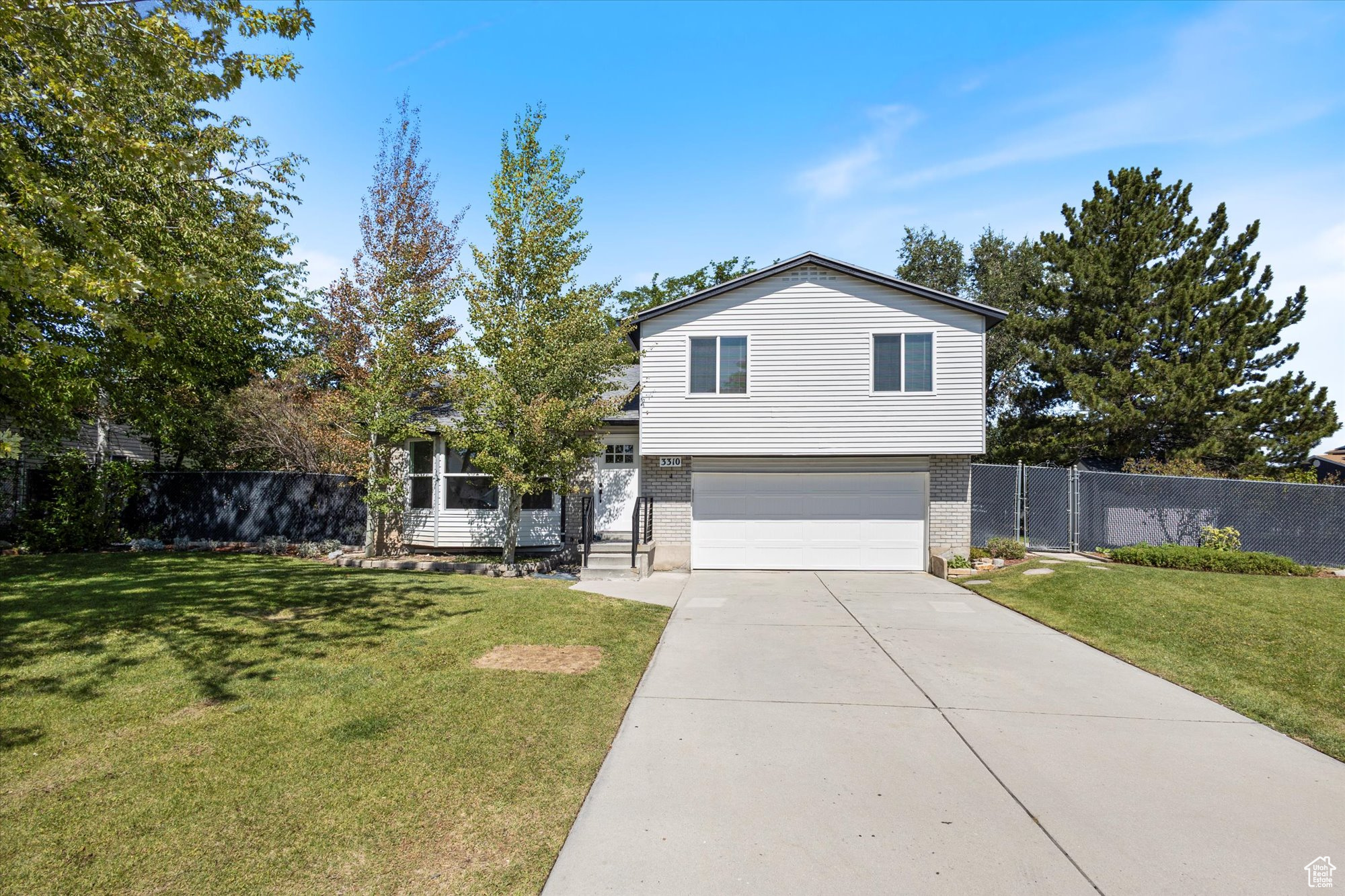 View of front of home featuring a front yard and a garage