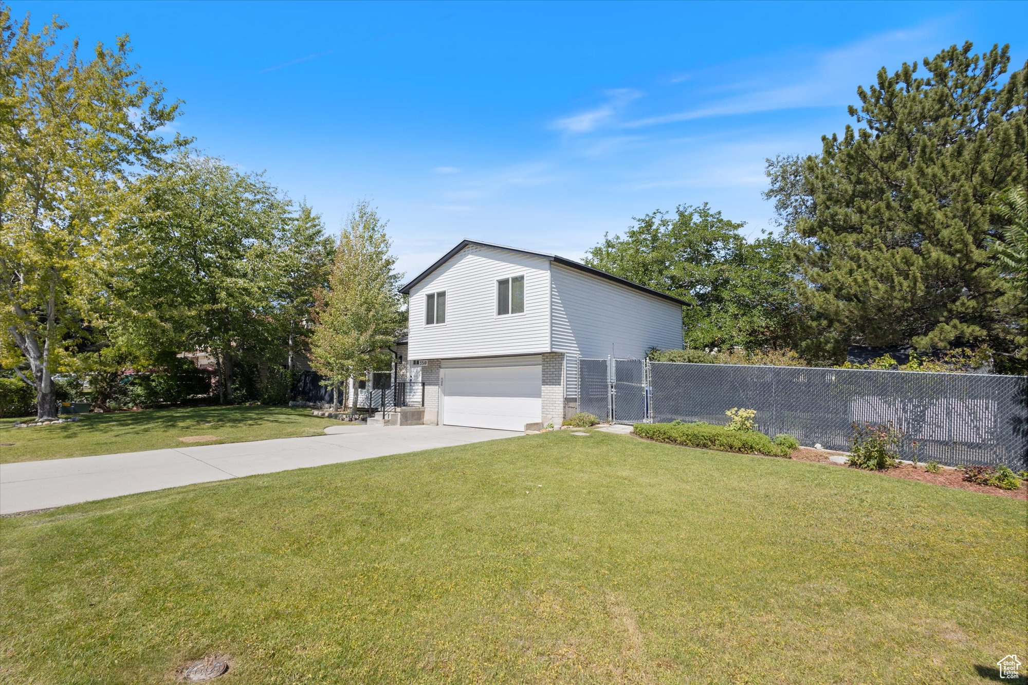 View of home's exterior with a yard and a garage