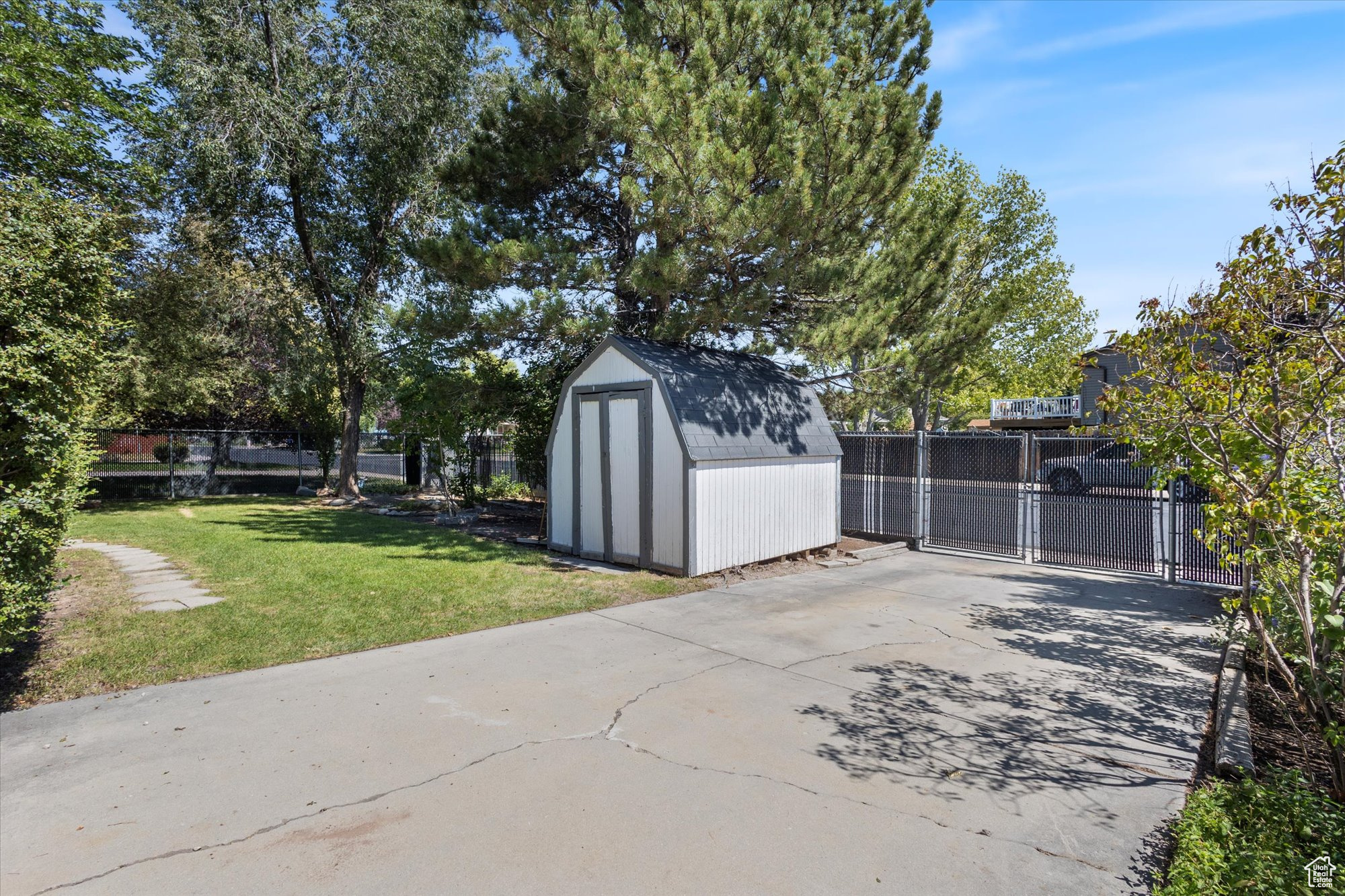 View of patio featuring a storage unit