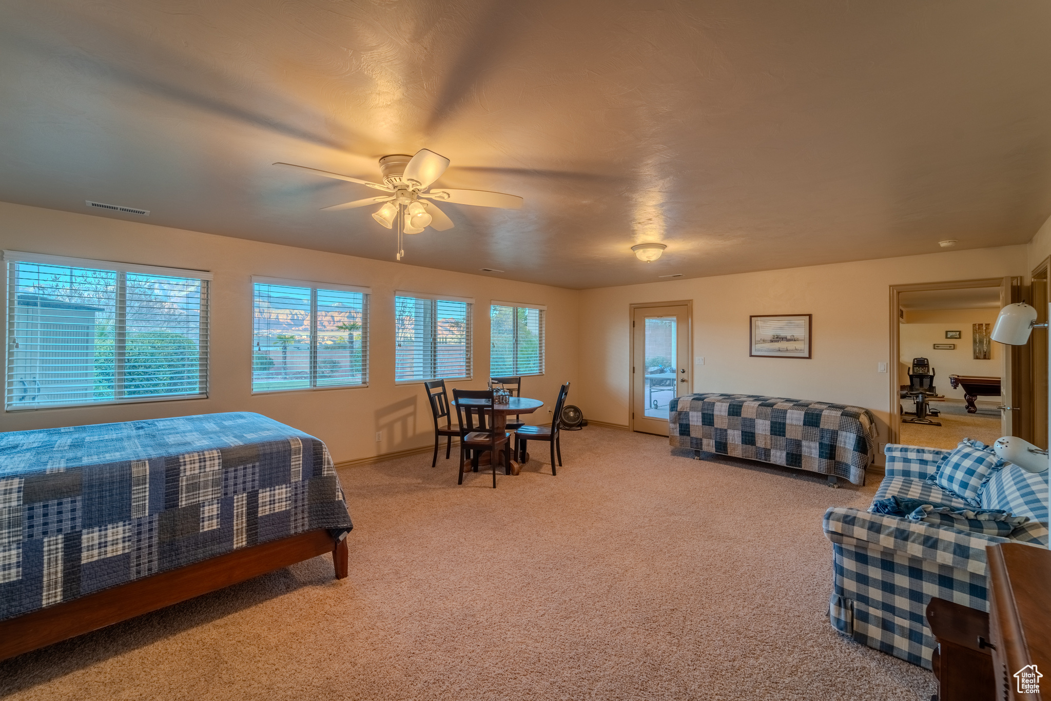 Carpeted bedroom featuring ceiling fan