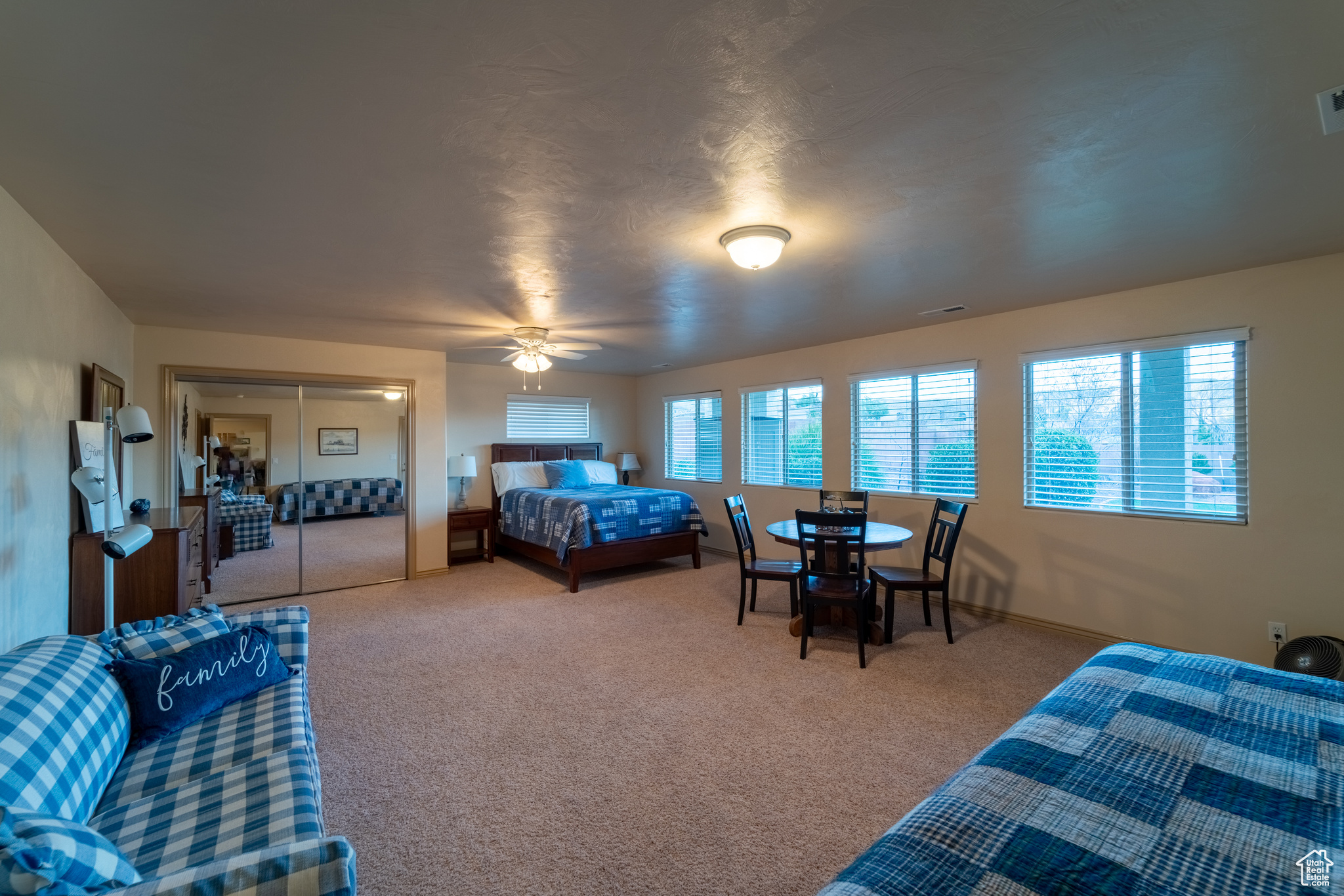 Carpeted bedroom with ceiling fan