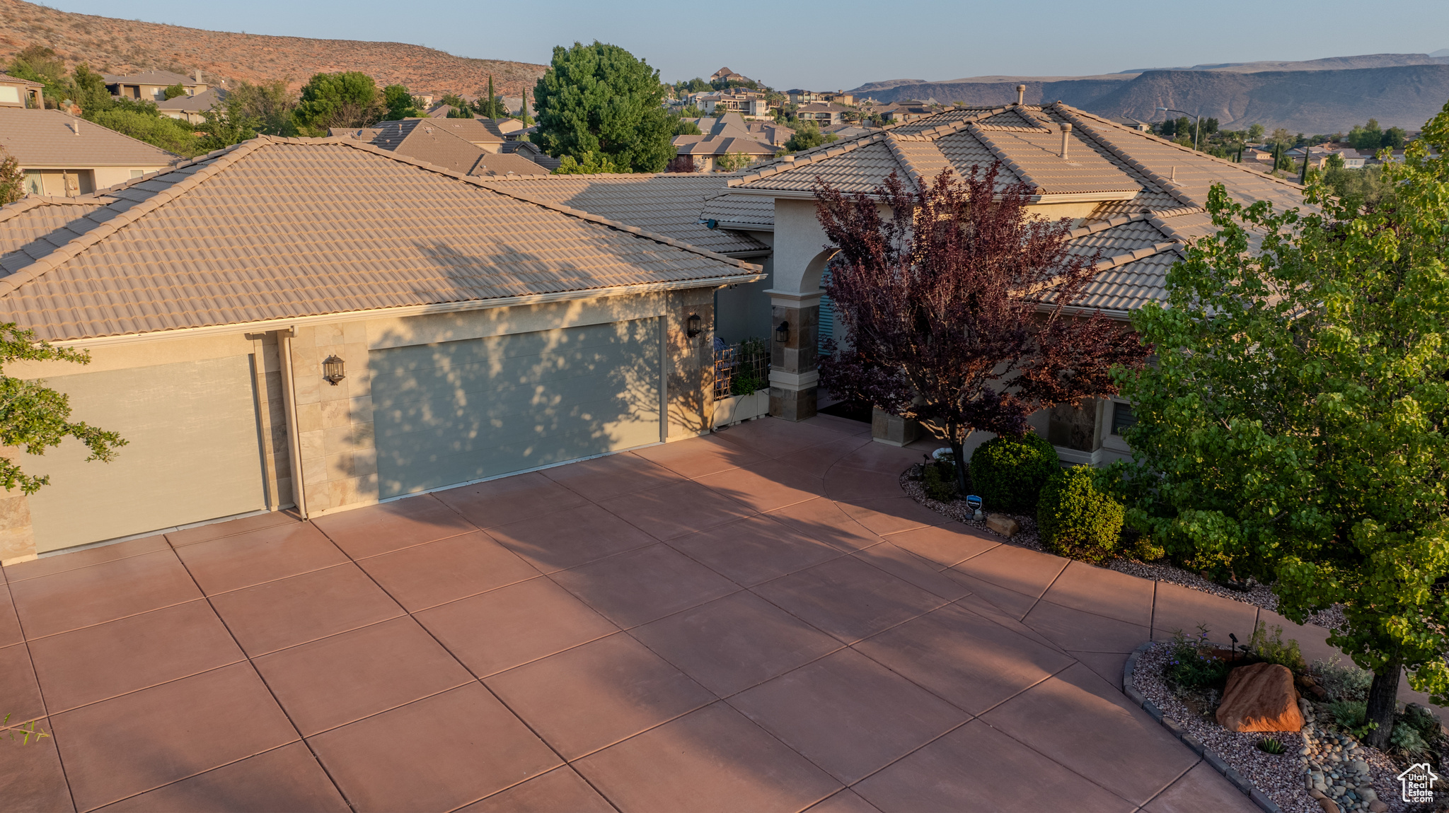 View of front of house with a mountain view and a garage