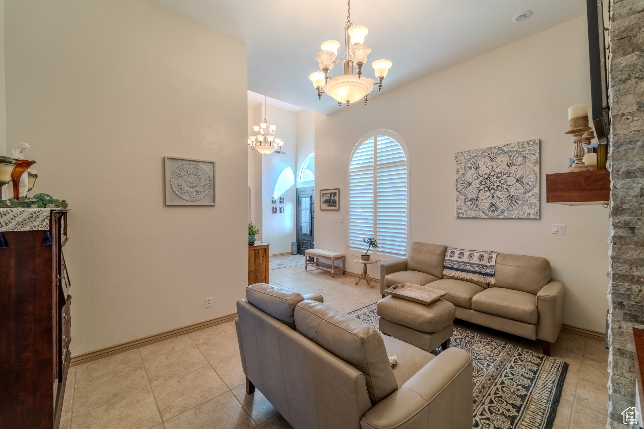 Tiled living room with an inviting chandelier