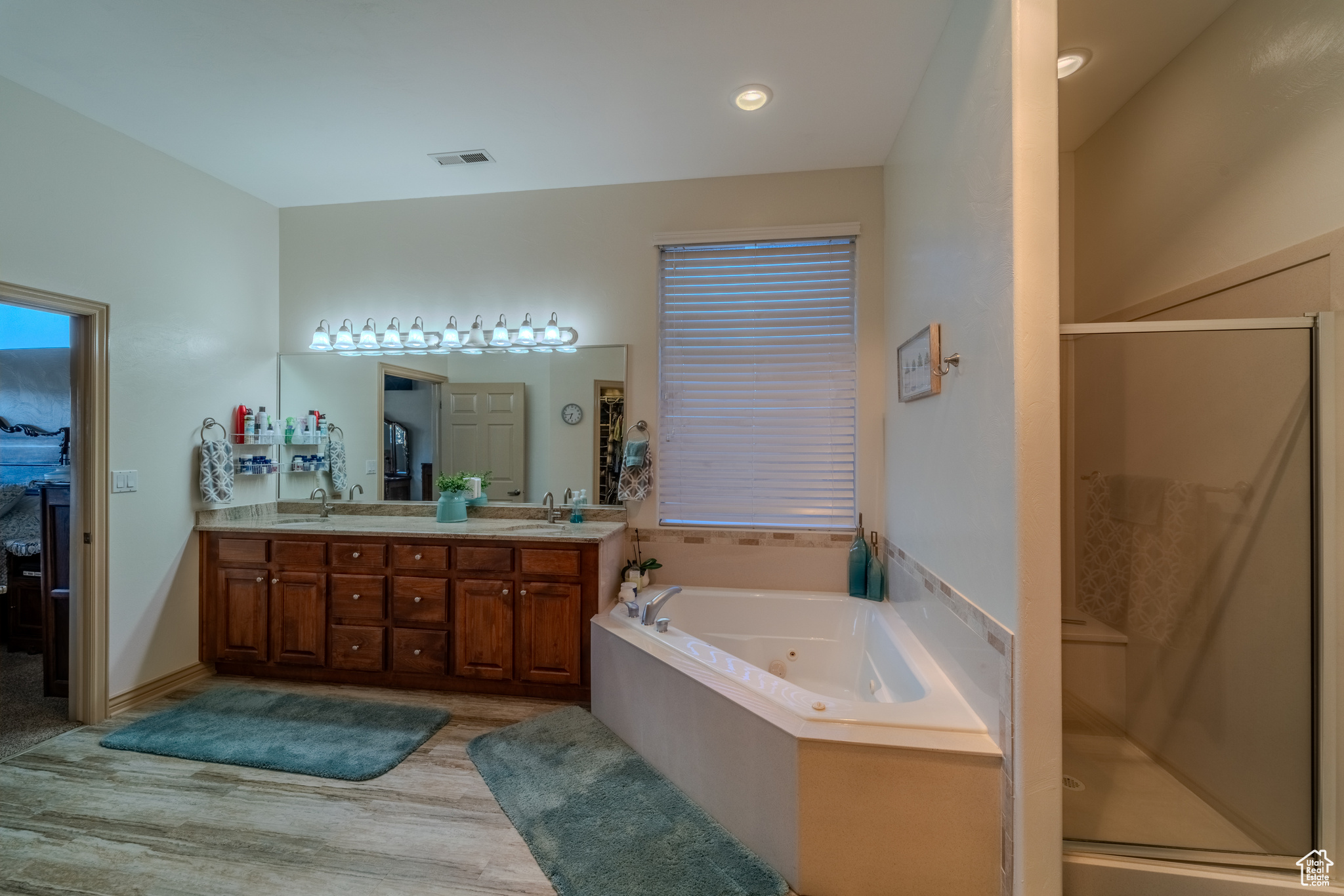 Bathroom featuring independent shower and bath, hardwood / wood-style flooring, and vanity