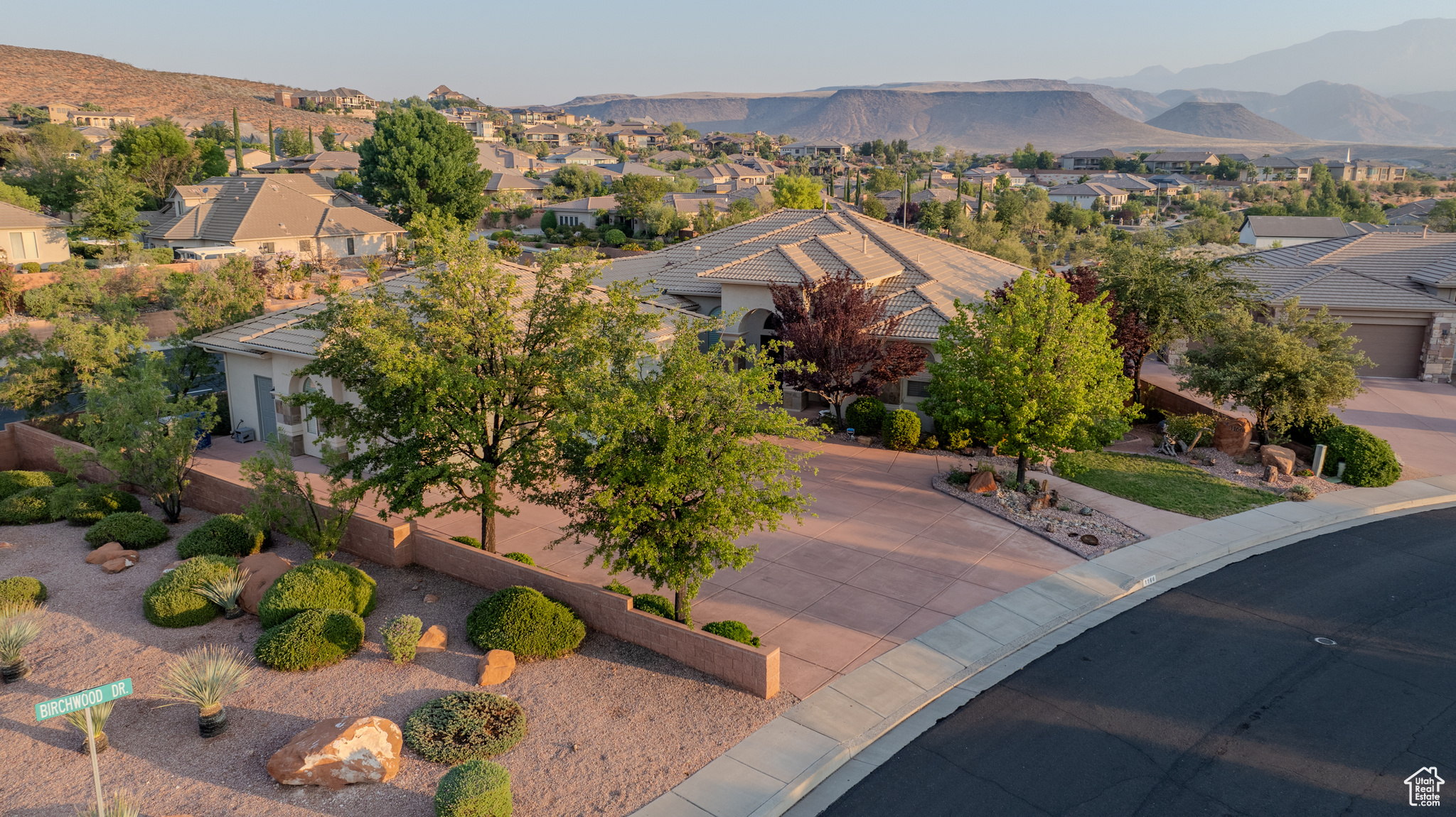 View of front of house with a mountain view and a garage